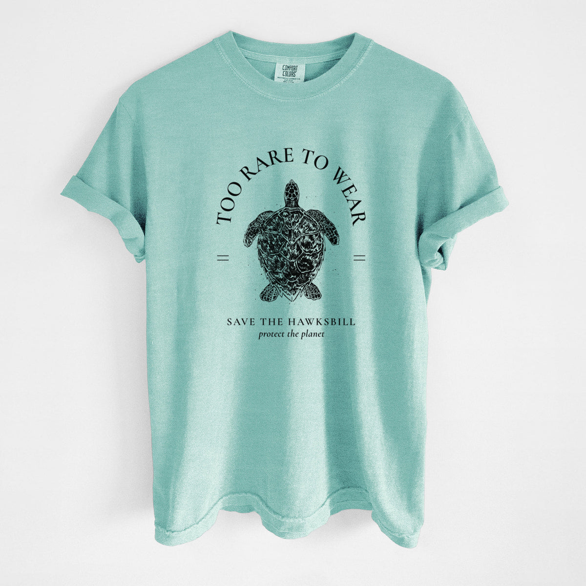 Chalky mint Comfort Colors t-shirt laid flat, printed with a black ink hawksbill sea turtle framed by the words Too Rare to Wear, Save the Hawksbill.