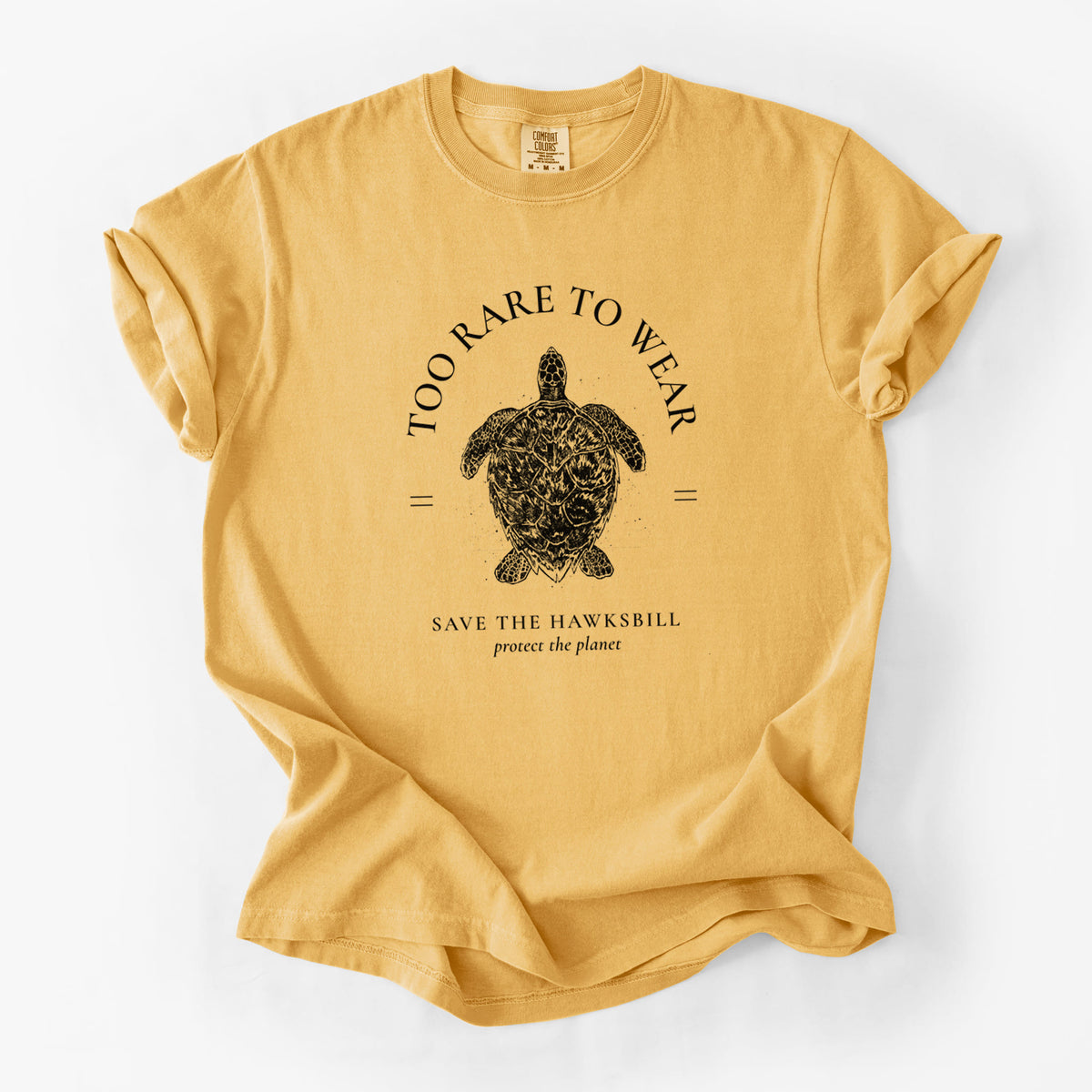 Golden wheat yellow Comfort Colors t-shirt laid flat, printed with a black ink hawksbill sea turtle framed by the words Too Rare to Wear, Save the Hawksbill.