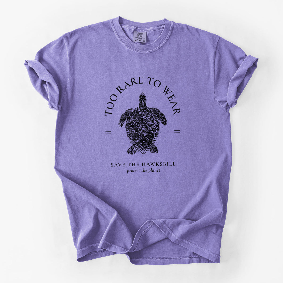 Violet purple Comfort Colors t-shirt laid flat, printed with a black ink hawksbill sea turtle framed by the words Too Rare to Wear, Save the Hawksbill.