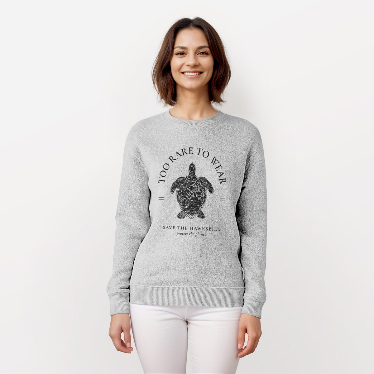 Woman wearing a knit sweatshirt printed with a black ink hawksbill sea turtle framed by the words Too Rare to Wear, Save the Hawksbill.