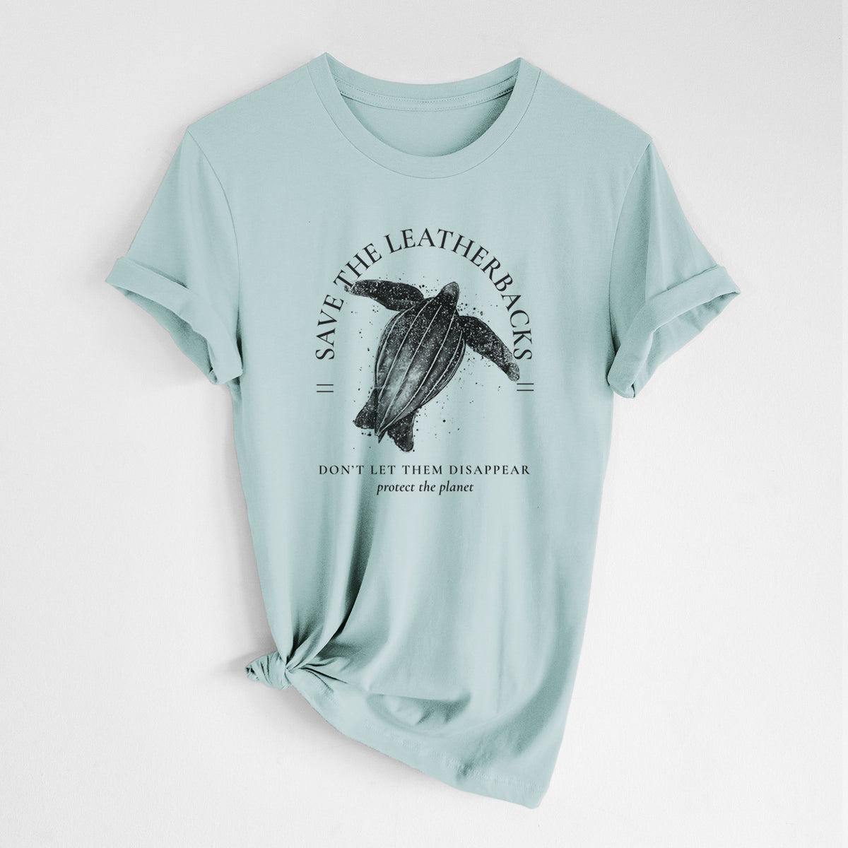 Dusty blue lightweight cotton t-shirt laid flat with the sleeves rolled, printed with a black ink leatherback sea turtle framed by the words Save the Leatherbacks, Don't Let Them Disappear.