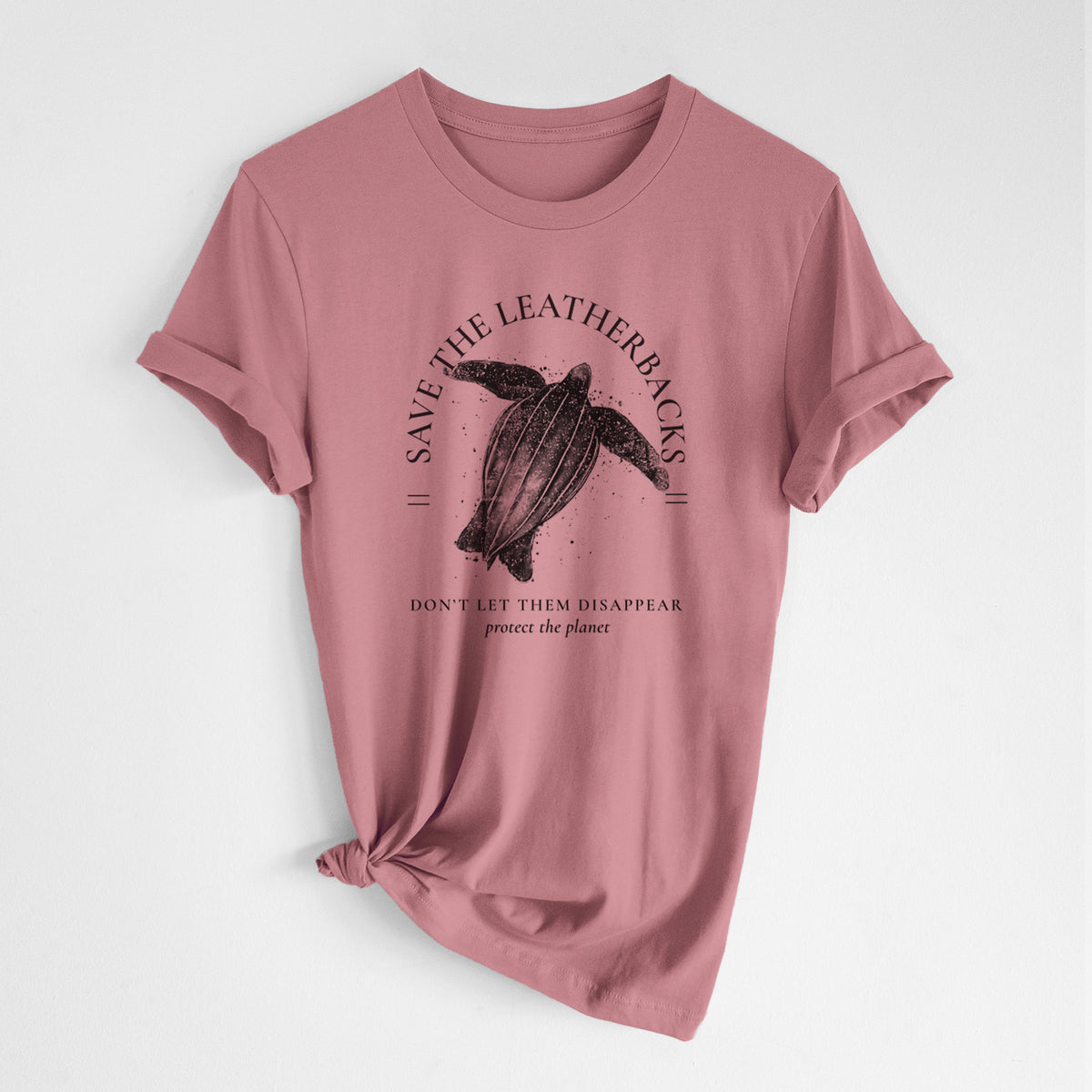 Mauve pink lightweight cotton t-shirt laid flat with the sleeves rolled, printed with a black ink leatherback sea turtle framed by the words Save the Leatherbacks, Don't Let Them Disappear.