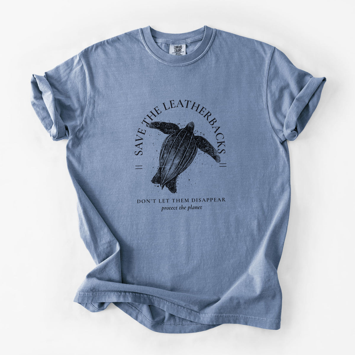 Blue jean Comfort Colors t-shirt laid flat, printed with a black ink leatherback sea turtle framed by the words Save the Leatherbacks, Don't Let Them Disappear.