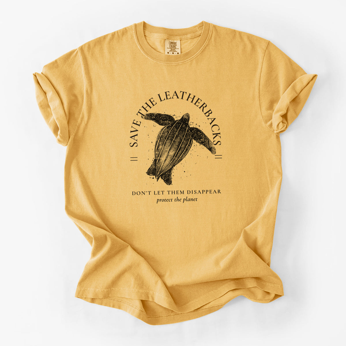 Golden wheat yellow Comfort Colors t-shirt laid flat, printed with a black ink leatherback sea turtle framed by the words Save the Leatherbacks, Don't Let Them Disappear.