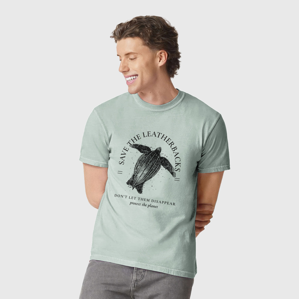 Man wearing a Comfort Colors t-shirt printed with a black ink leatherback sea turtle framed by the words Save the Leatherbacks, Don't Let Them Disappear.