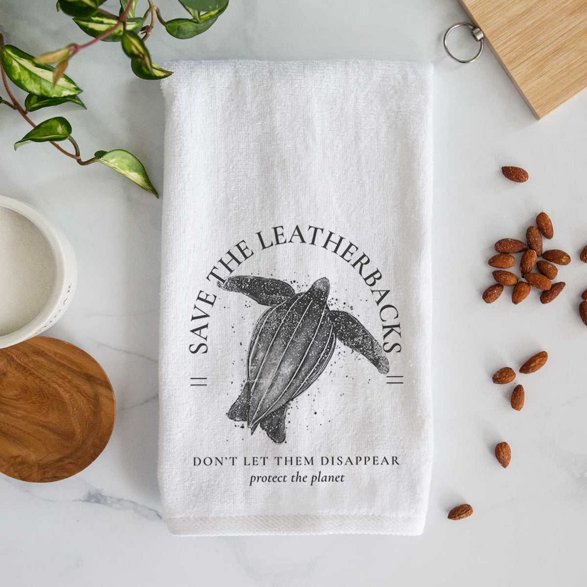 White hand towel printed with a black ink leatherback sea turtle framed by the words Save the Leatherbacks, Don't Let Them Disappear.