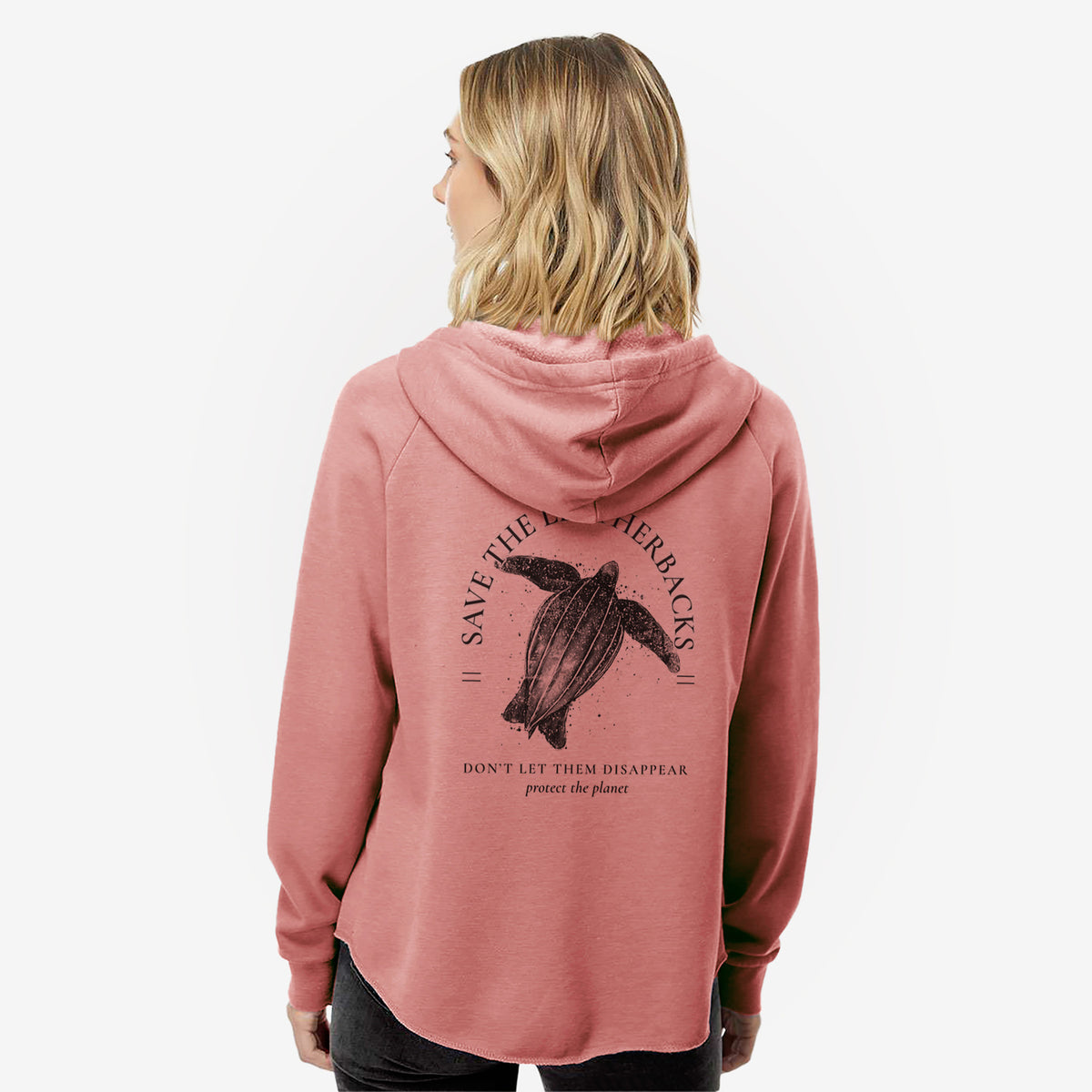 Woman wearing a dusty rose women's Cali Wave zip-up sweatshirt printed with a black ink leatherback sea turtle framed by the words Save the Leatherbacks, Don't Let Them Disappear, seen from behind.