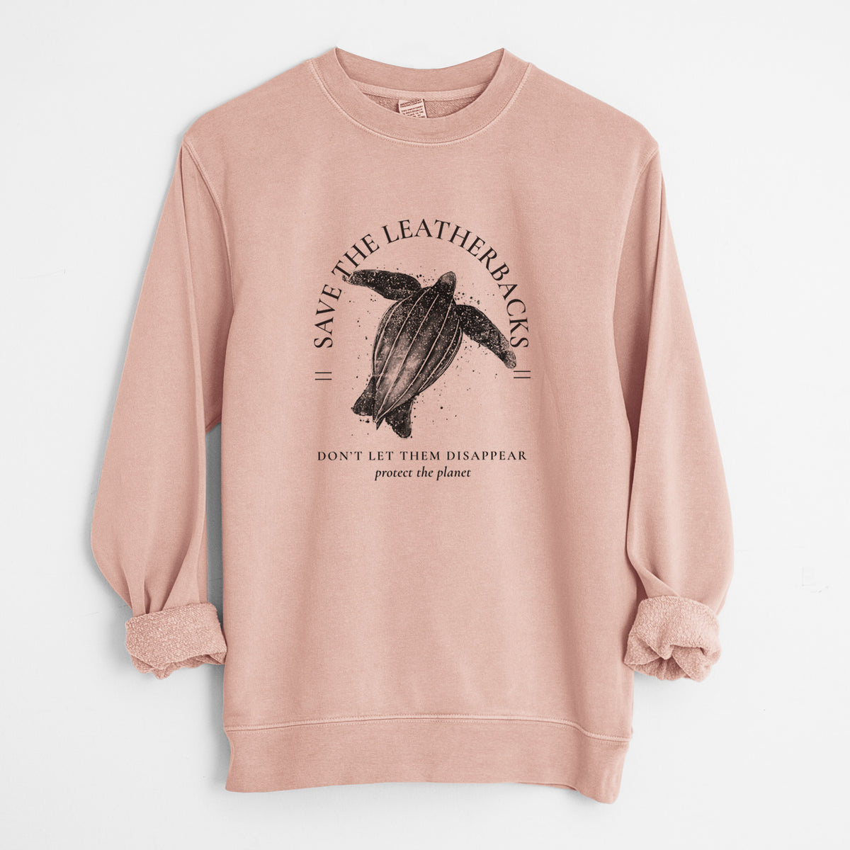 Dusty pink pigment dyed crewneck sweatshirt laid flat with the sleeves rolled, printed with a black ink leatherback sea turtle framed by the words Save the Leatherbacks, Don't Let Them Disappear.