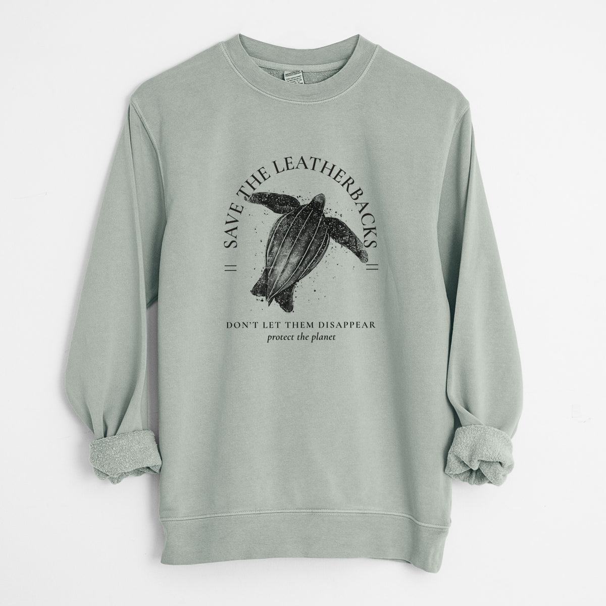 Sage green pigment dyed crewneck sweatshirt laid flat with the sleeves rolled, printed with a black ink leatherback sea turtle framed by the words Save the Leatherbacks, Don't Let Them Disappear.