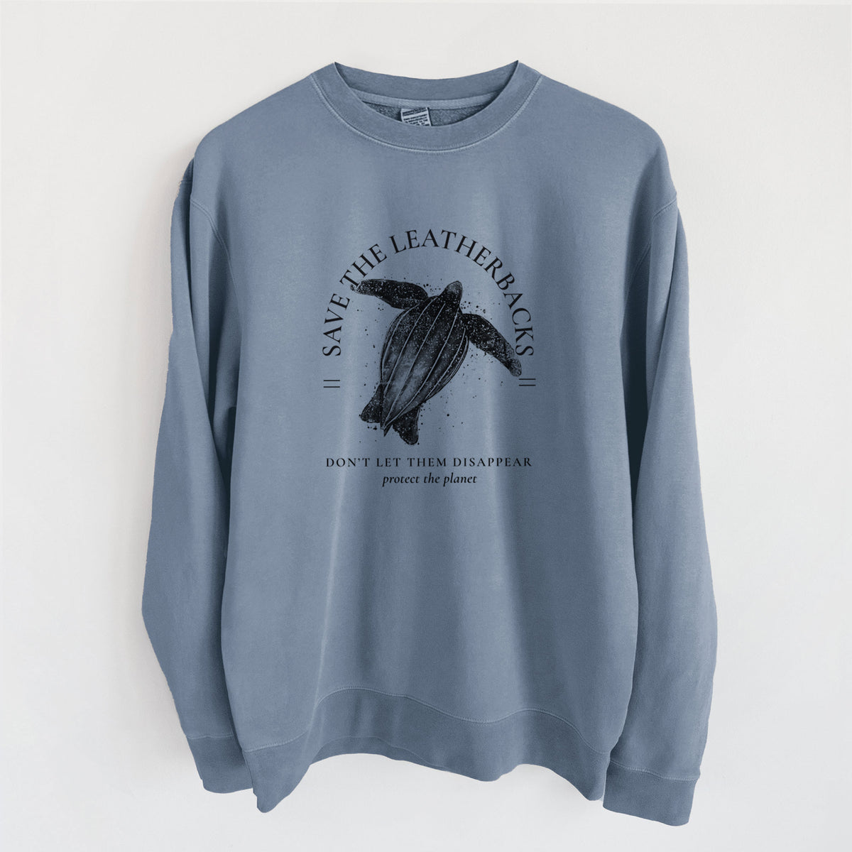 Slate blue pigment dyed crewneck sweatshirt laid flat, printed with a black ink leatherback sea turtle framed by the words Save the Leatherbacks, Don't Let Them Disappear.
