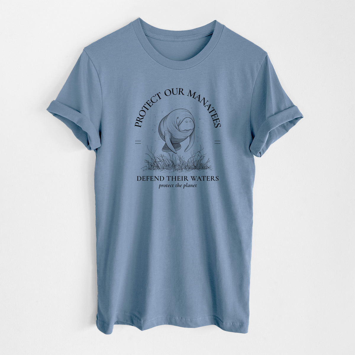 Steel blue lightweight cotton t-shirt laid flat, printed with a black ink illustration of a manatee among seagrass, framed by the words Protect Our Manatees, Defend Their Waters, Protect the Planet.