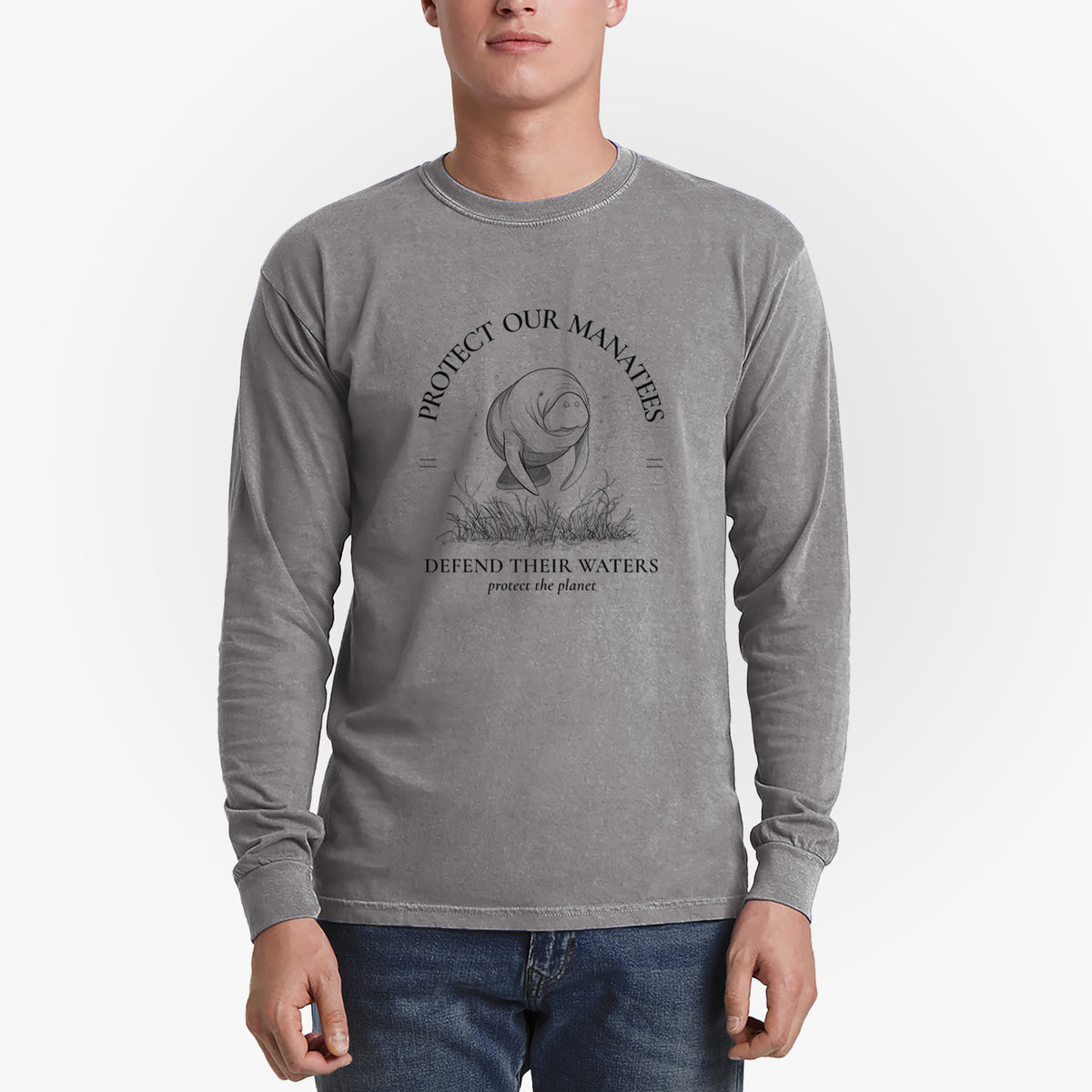Man wearing a grey Comfort Colors long sleeve shirt printed with a black ink illustration of a manatee among seagrass, framed by the words Protect Our Manatees, Defend Their Waters, Protect the Planet.