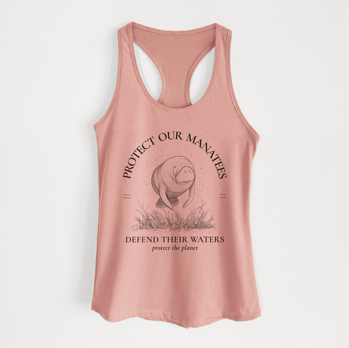 Desert pink women's racerback tank top laid flat, printed with a black ink illustration of a manatee among seagrass, framed by the words Protect Our Manatees, Defend Their Waters, Protect the Planet.