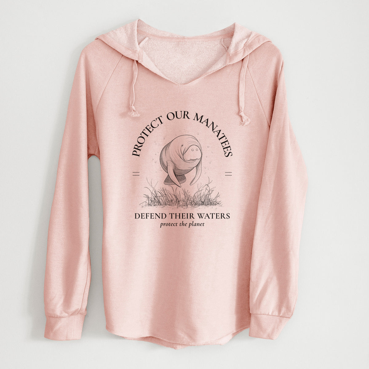 Blush pink women's Cali Wave hooded sweatshirt laid flat, printed with a black ink illustration of a manatee among seagrass, framed by the words Protect Our Manatees, Defend Their Waters, Protect the Planet.