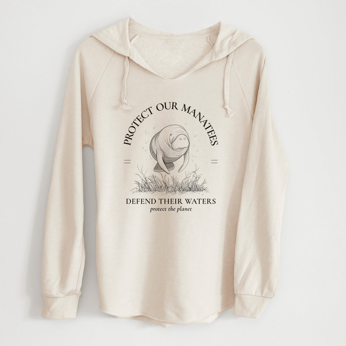 Bone cream women's Cali Wave hooded sweatshirt laid flat, printed with a black ink illustration of a manatee among seagrass, framed by the words Protect Our Manatees, Defend Their Waters, Protect the Planet.