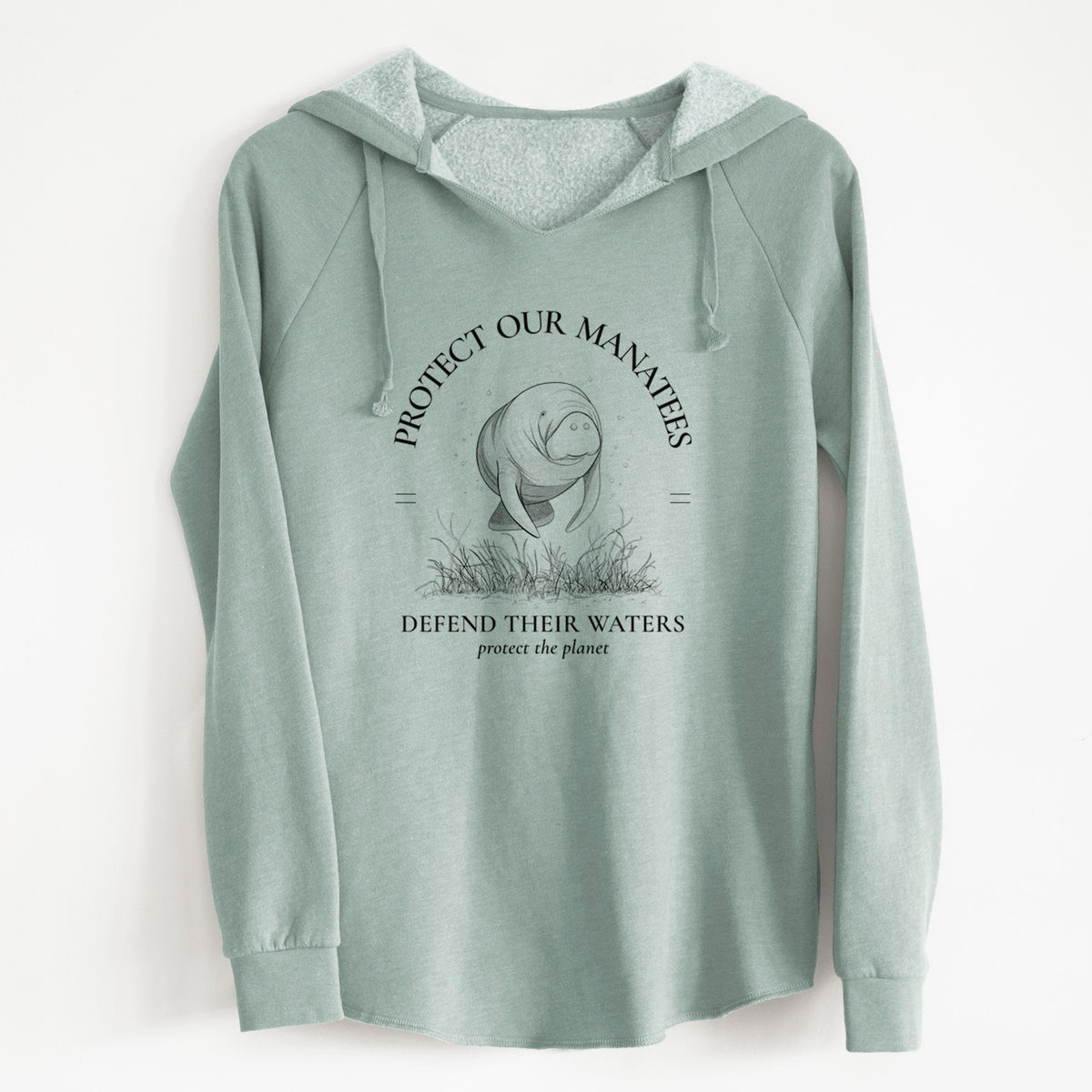 Sage green women's Cali Wave hooded sweatshirt laid flat, printed with a black ink illustration of a manatee among seagrass, framed by the words Protect Our Manatees, Defend Their Waters, Protect the Planet.