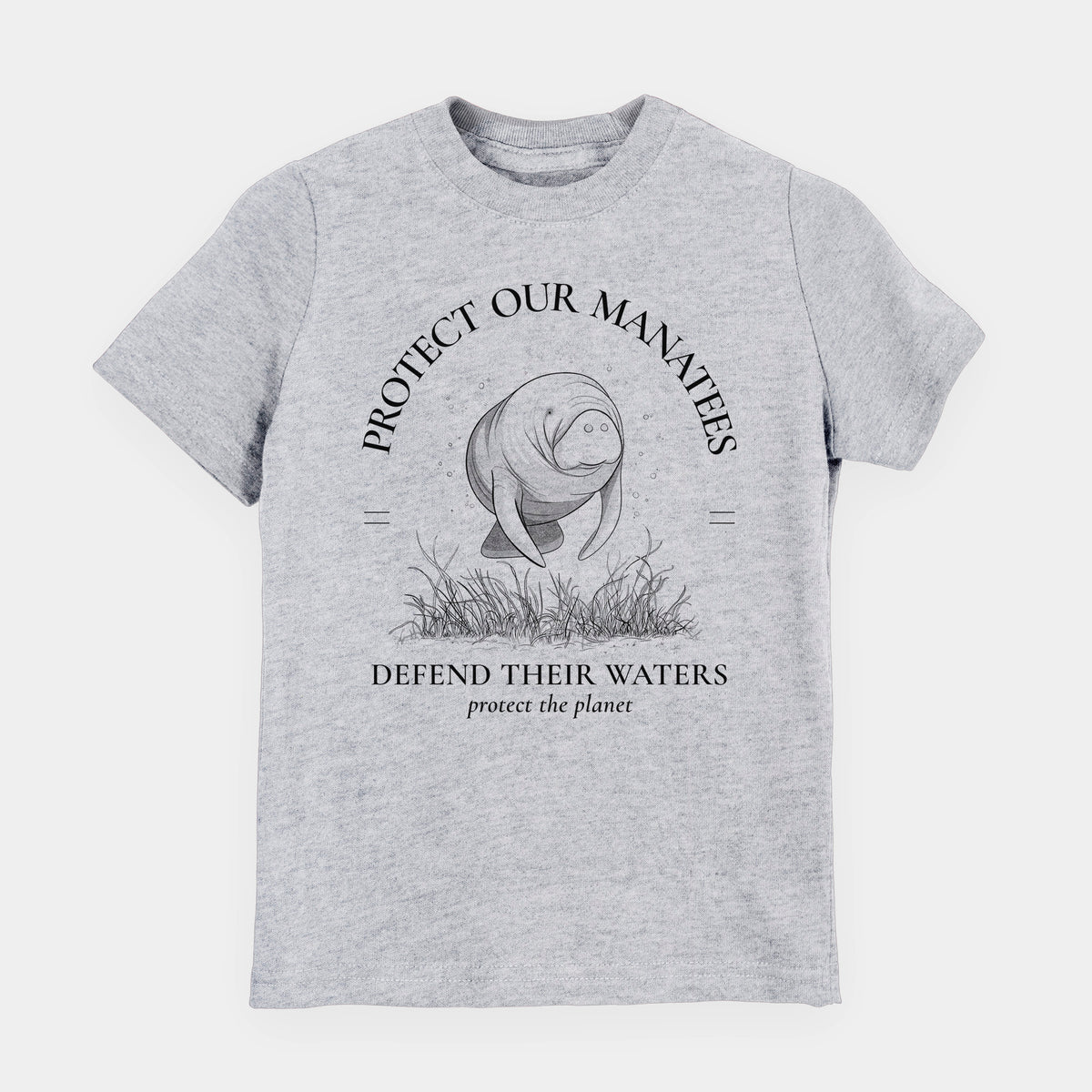 Heather grey youth t-shirt laid flat, printed with a black ink illustration of a manatee among seagrass, framed by the words Protect Our Manatees, Defend Their Waters, Protect the Planet.