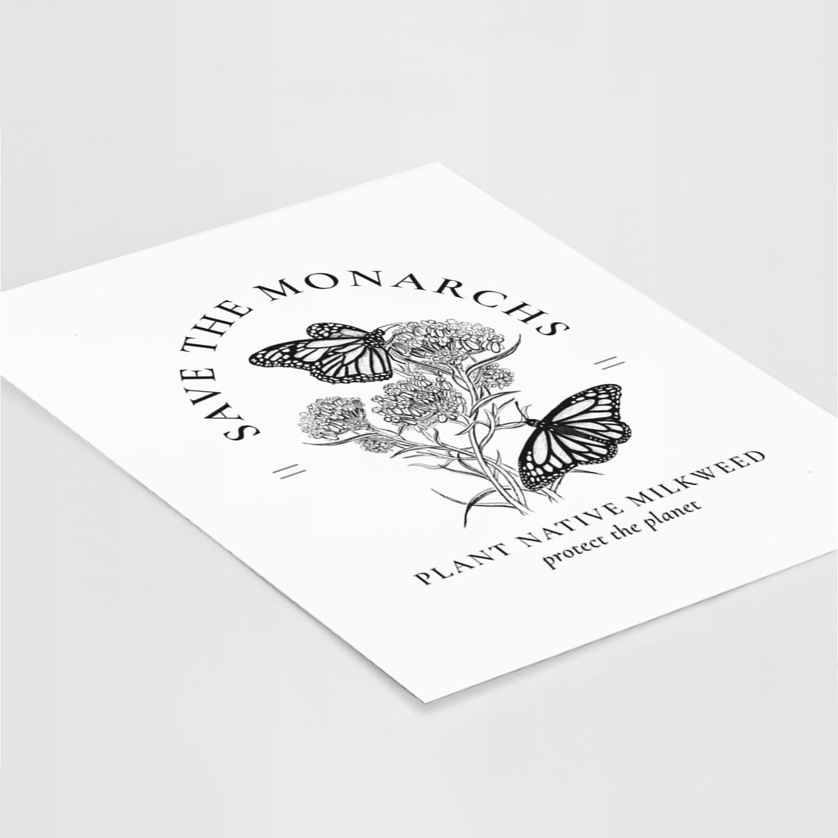 Art print of black ink monarch butterflies on milkweed flowers, framed by the words Save the Monarchs, Plant Native Milkweed, lying at an angle on a white surface.
