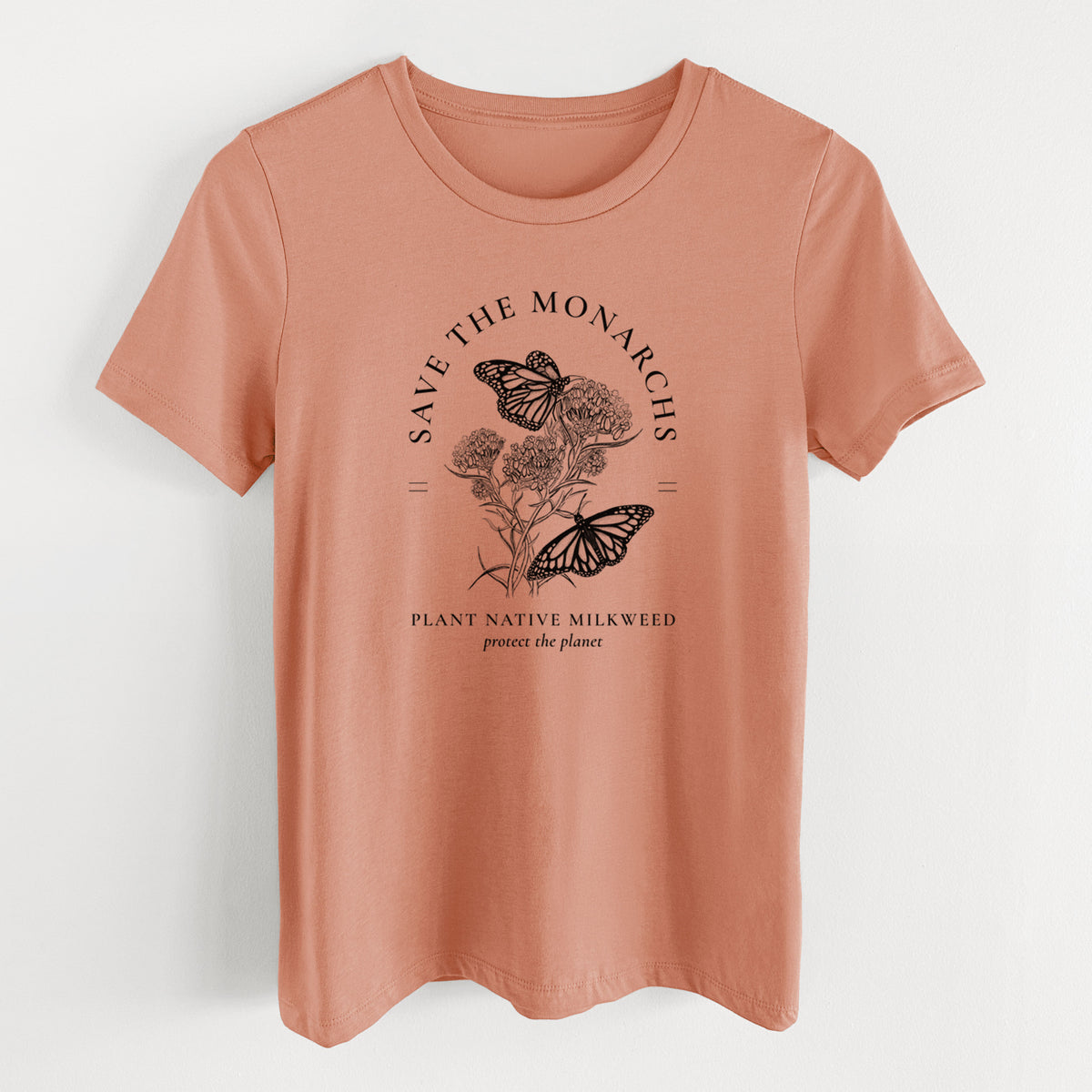 Terracotta orange women's relaxed fit cotton t-shirt laid flat, printed with black ink monarch butterflies on milkweed flowers, framed by the words Save the Monarchs, Plant Native Milkweed.