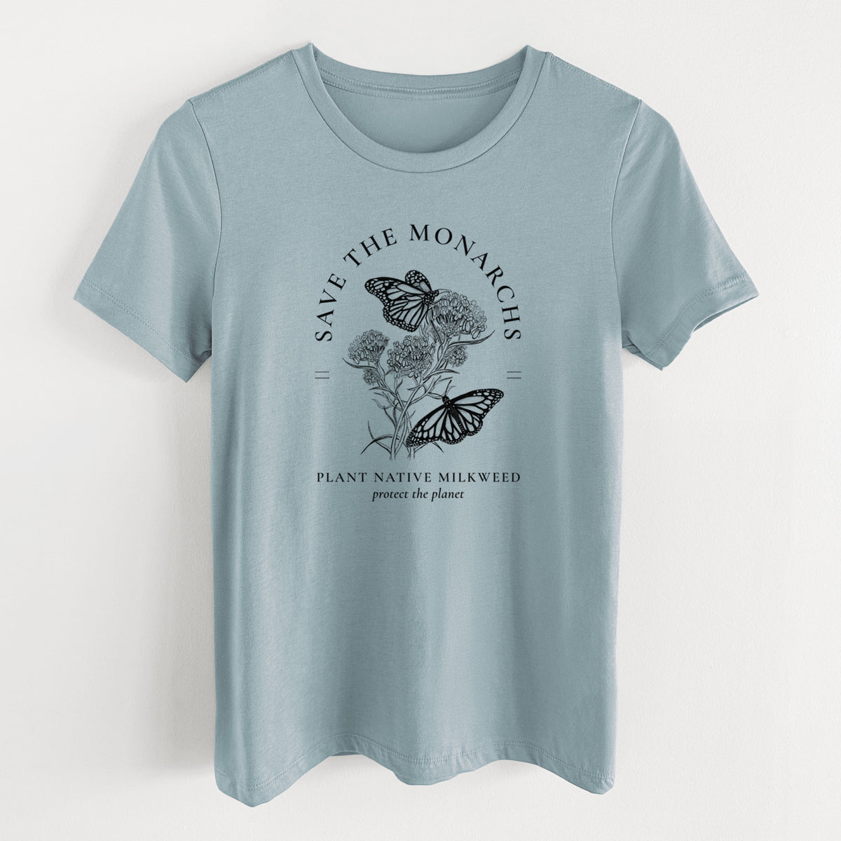 Vintage denim women's relaxed fit cotton t-shirt laid flat, printed with black ink monarch butterflies on milkweed flowers, framed by the words Save the Monarchs, Plant Native Milkweed.