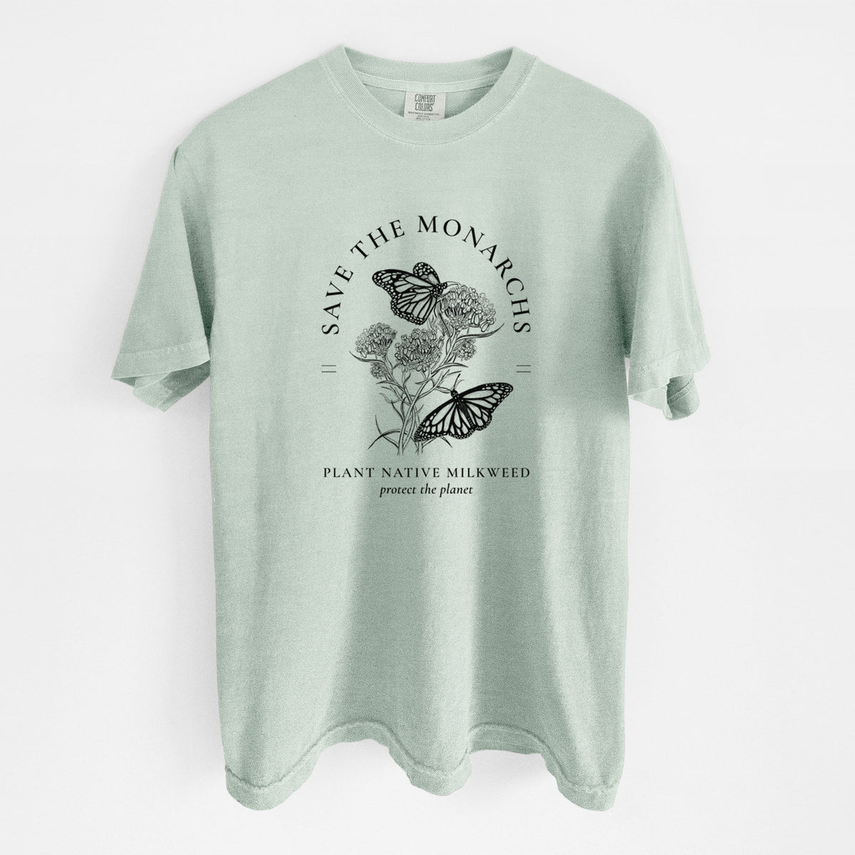 Bay green Comfort Colors t-shirt laid flat, printed with black ink monarch butterflies on milkweed flowers, framed by the words Save the Monarchs, Plant Native Milkweed.