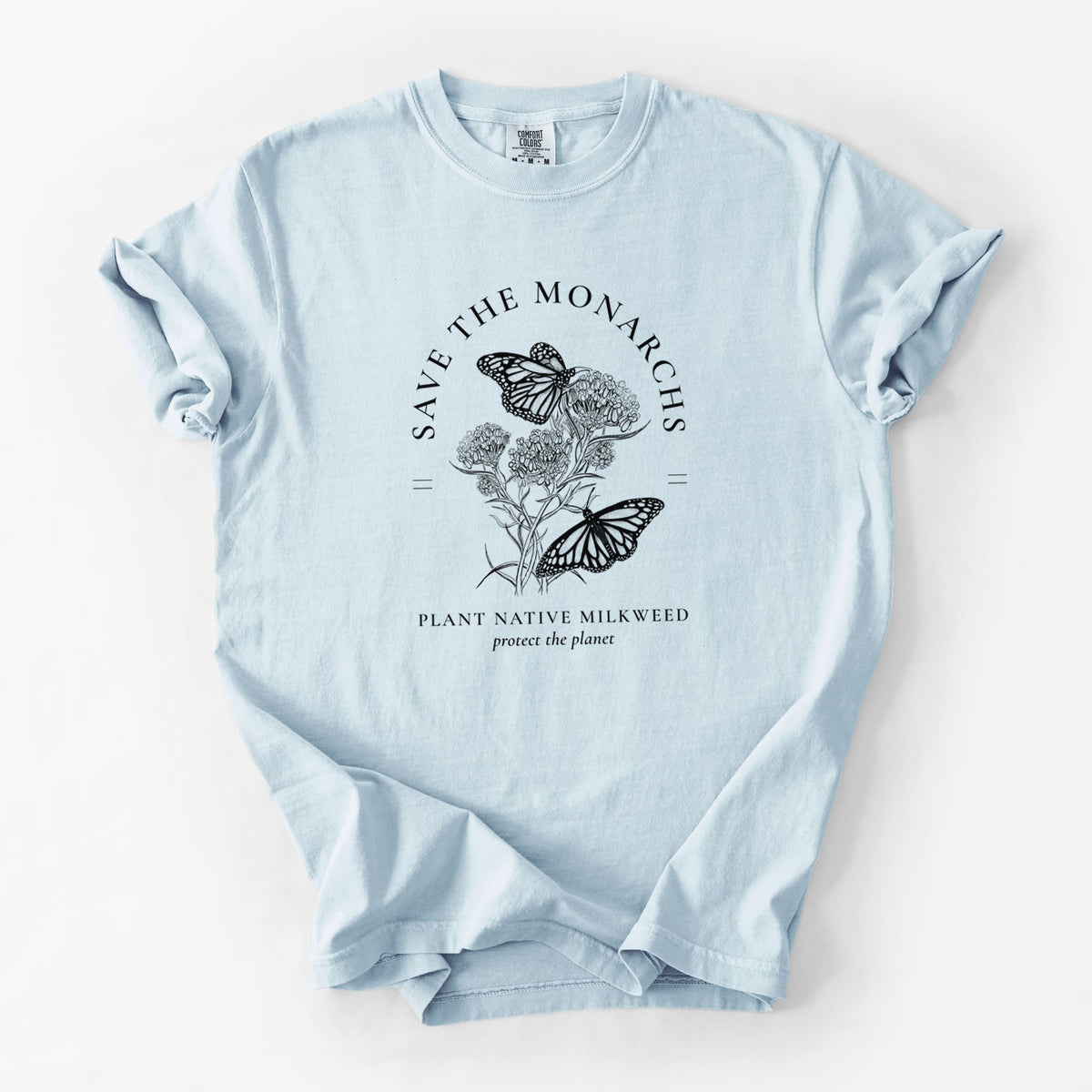 Chambray blue Comfort Colors t-shirt laid flat, printed with black ink monarch butterflies on milkweed flowers, framed by the words Save the Monarchs, Plant Native Milkweed.