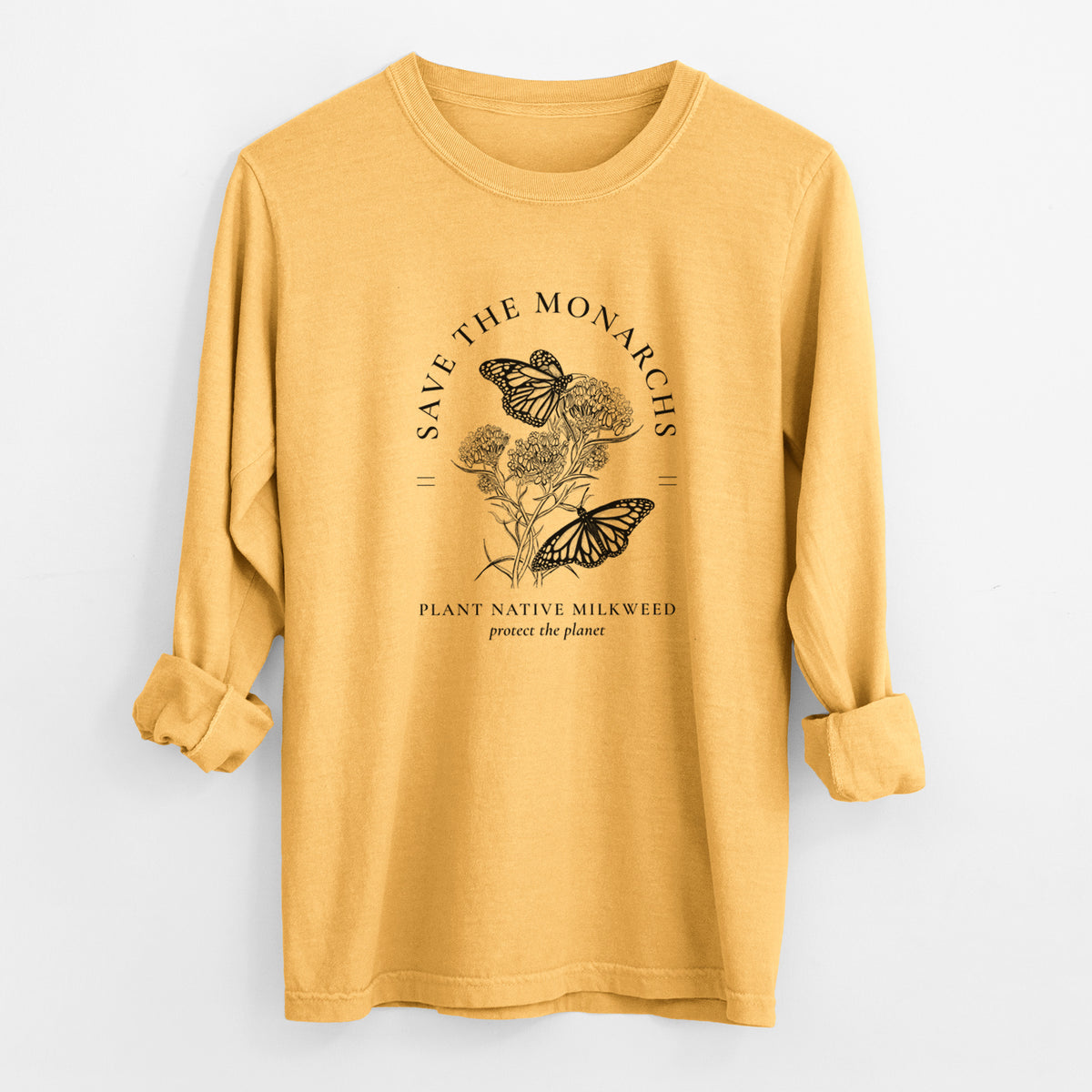 Golden wheat yellow Comfort Colors long sleeve shirt laid flat with the cuffs rolled, printed with black ink monarch butterflies on milkweed flowers, framed by the words Save the Monarchs, Plant Native Milkweed.