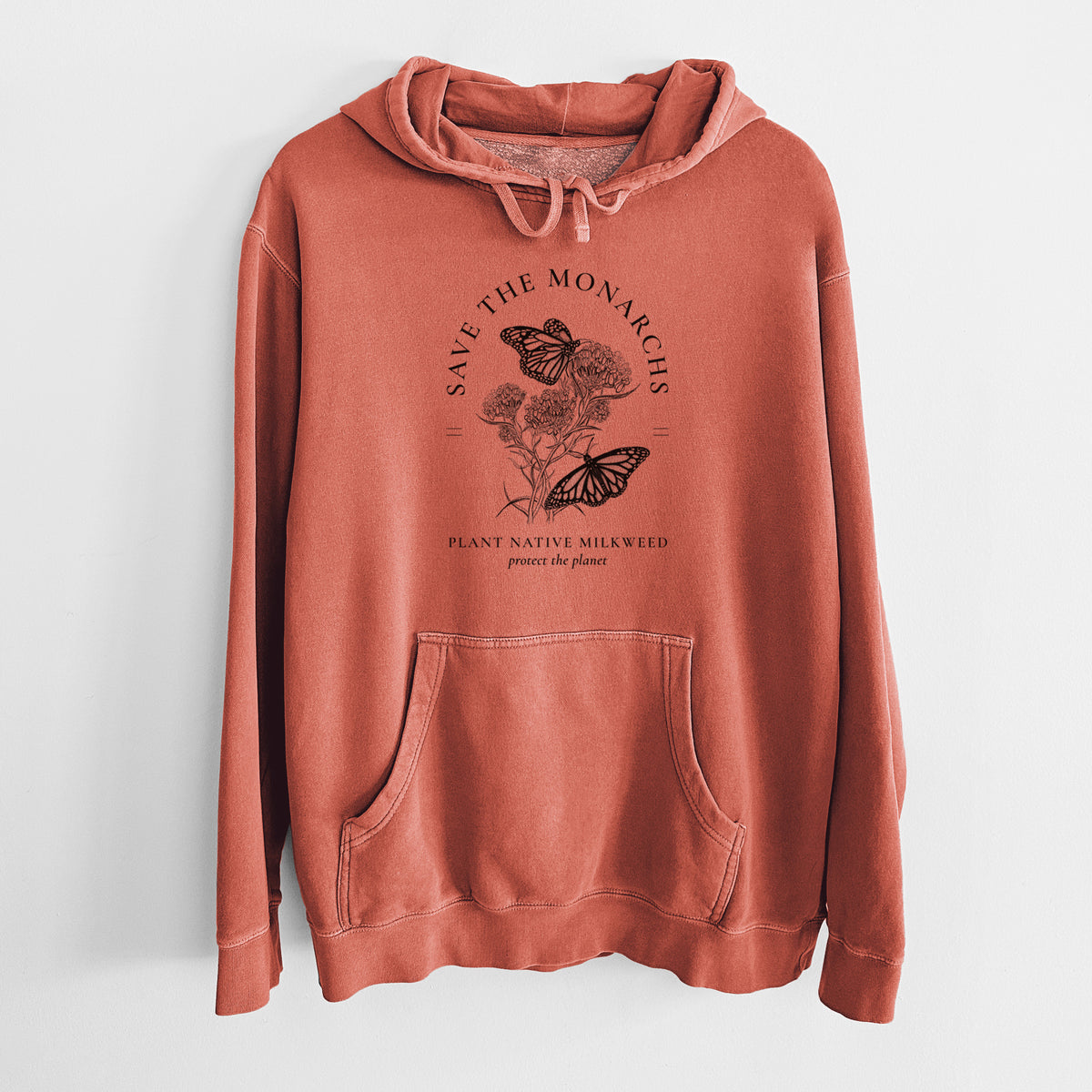 Amber orange pigment dyed hoodie laid flat, printed with black ink monarch butterflies on milkweed flowers, framed by the words Save the Monarchs, Plant Native Milkweed.