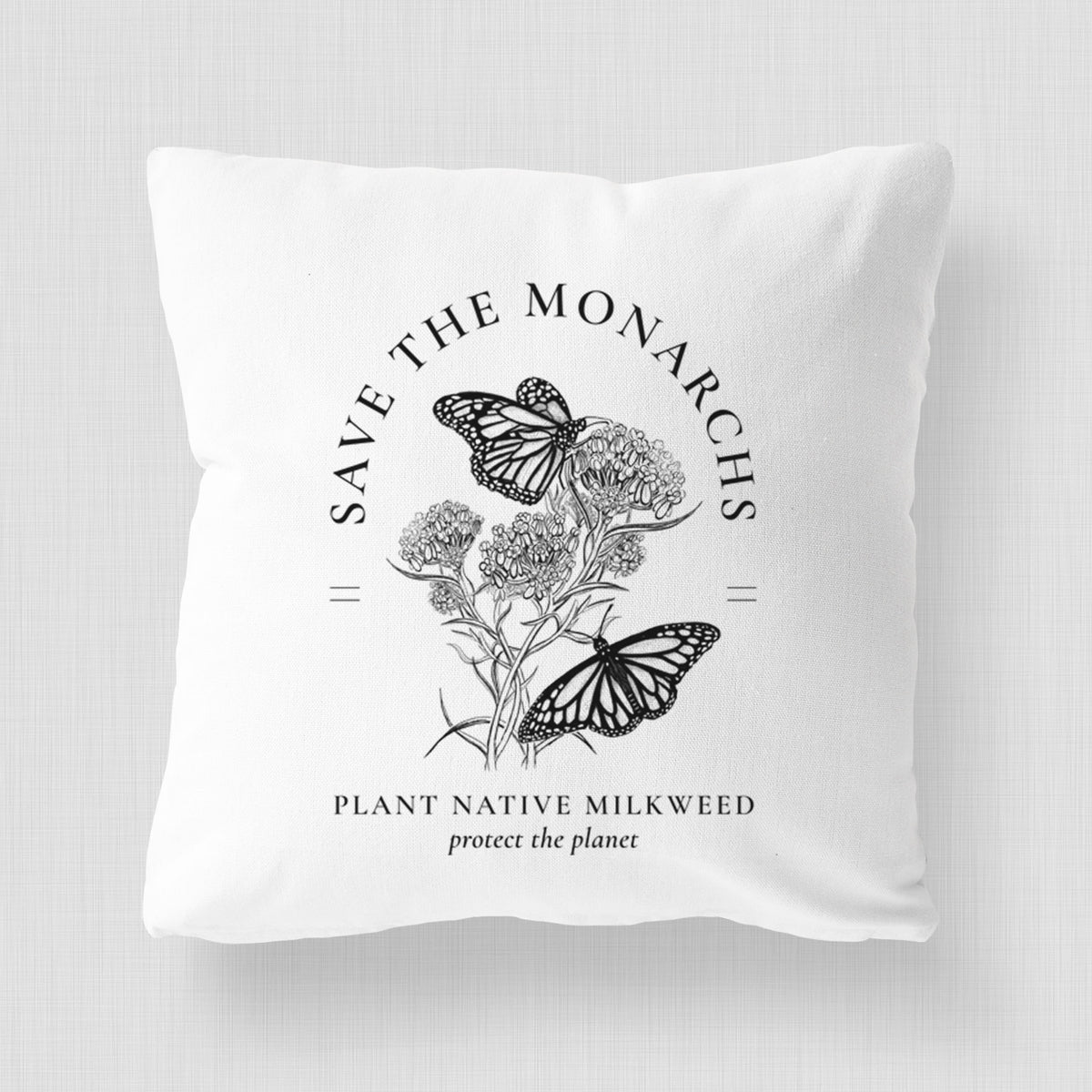 White pillow cover printed with black ink monarch butterflies on milkweed flowers, framed by the words Save the Monarchs, Plant Native Milkweed.