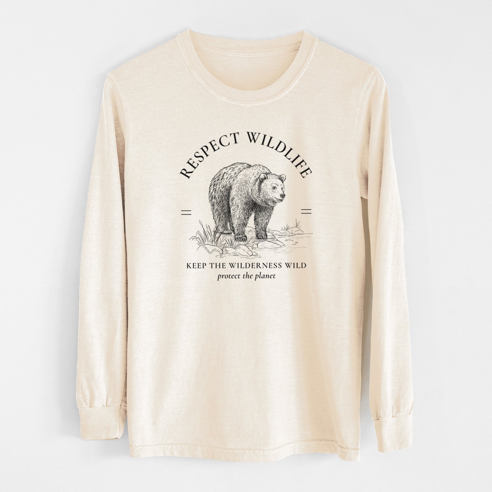 Ivory Comfort Colors long sleeve shirt laid flat, printed with a black ink bear framed by the words Respect Wildlife, Keep the Wilderness Wild.