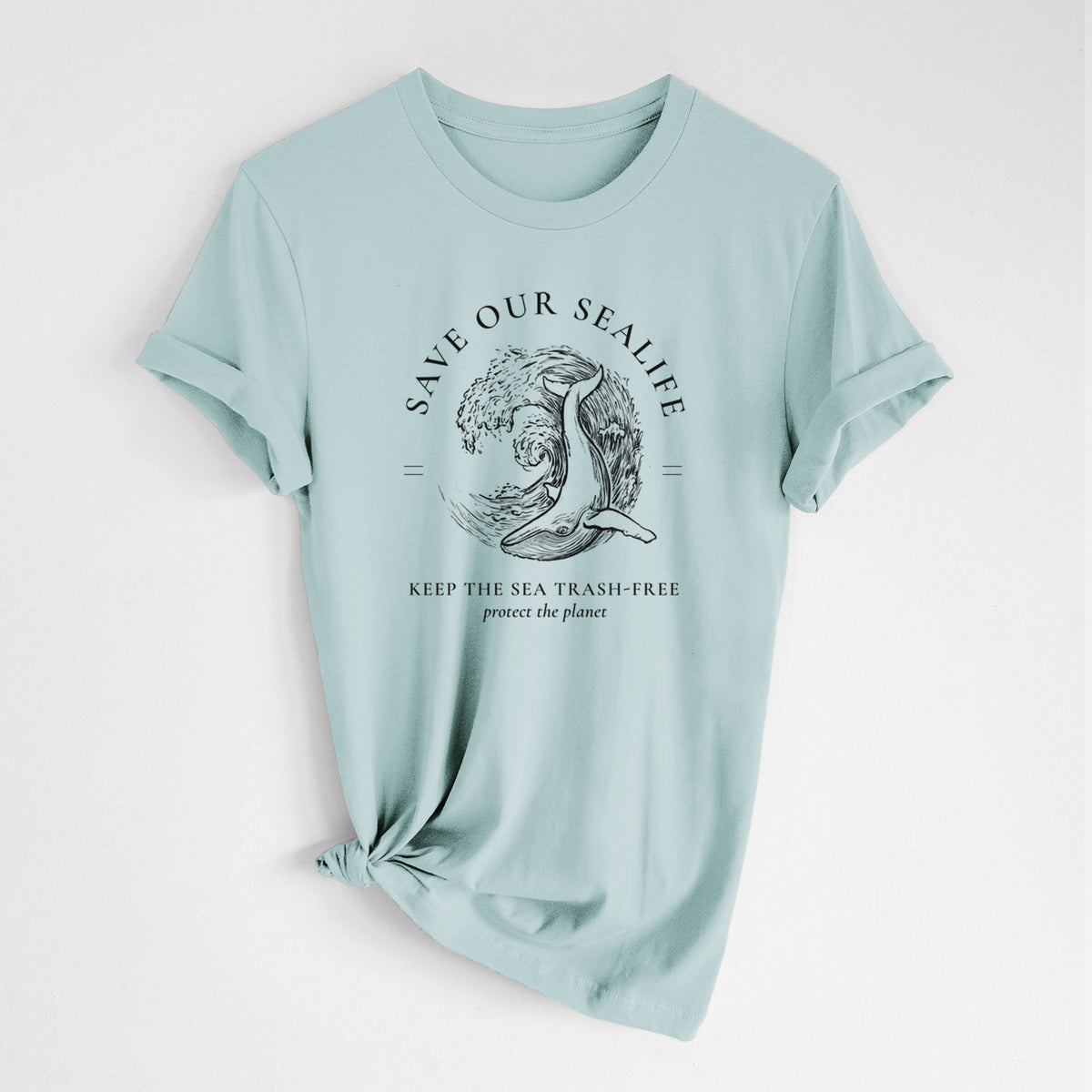 Dusty blue lightweight cotton t-shirt laid flat with the sleeves rolled, printed with a black ink whale in an ocean wave framed by the words Save Our Sealife, Keep the Sea Trash-Free.
