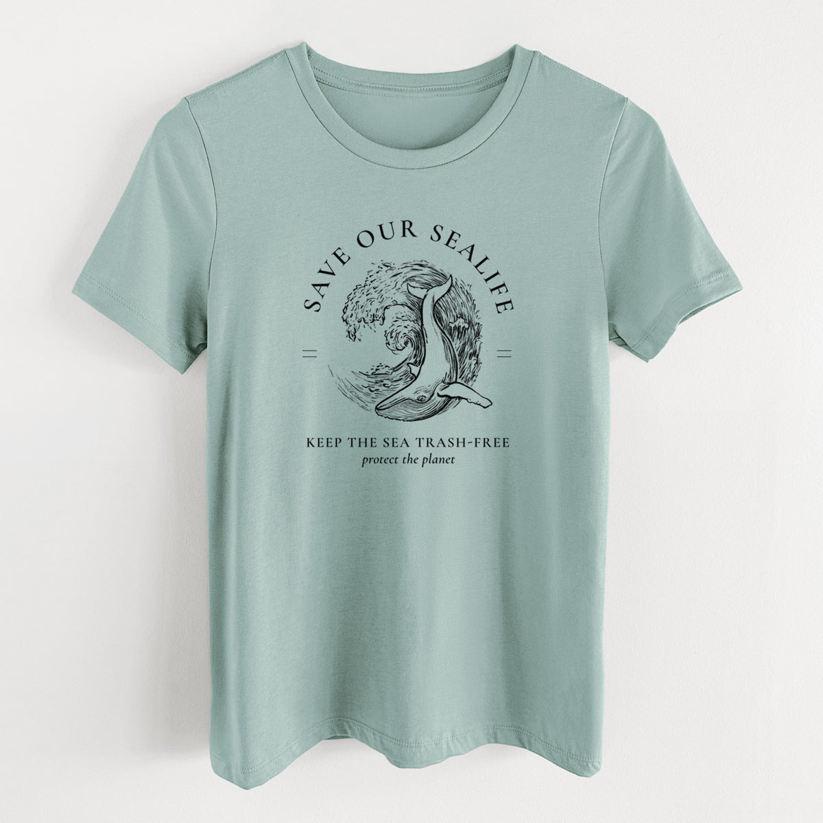 Dusty blue women's relaxed fit cotton t-shirt laid flat, printed with a black ink whale in an ocean wave framed by the words Save Our Sealife, Keep the Sea Trash-Free.
