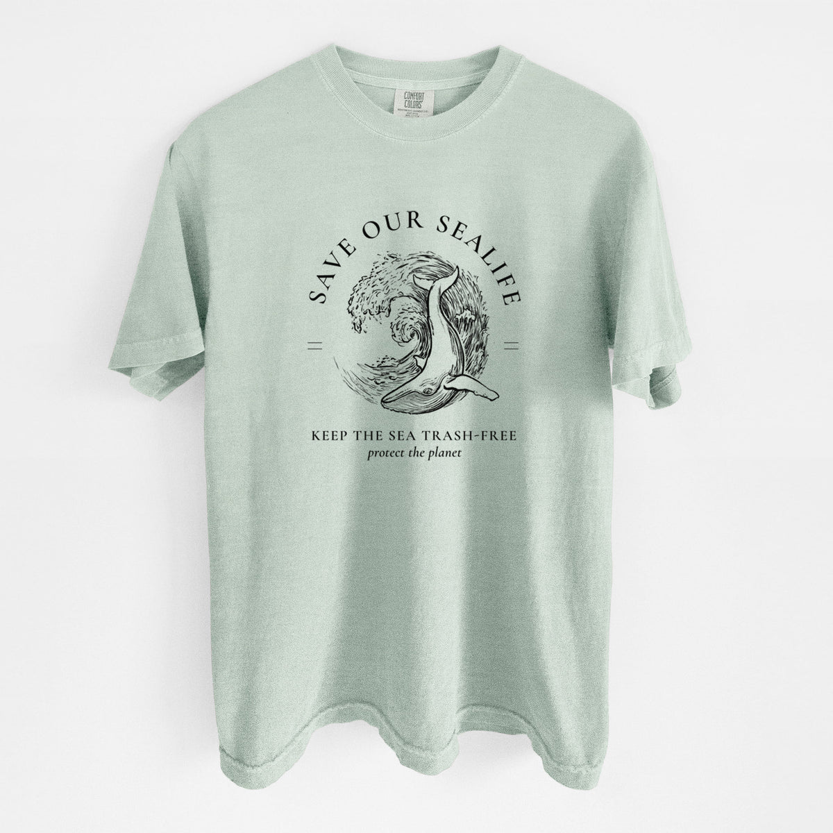 Bay green Comfort Colors t-shirt laid flat, printed with a black ink whale in an ocean wave framed by the words Save Our Sealife, Keep the Sea Trash-Free.