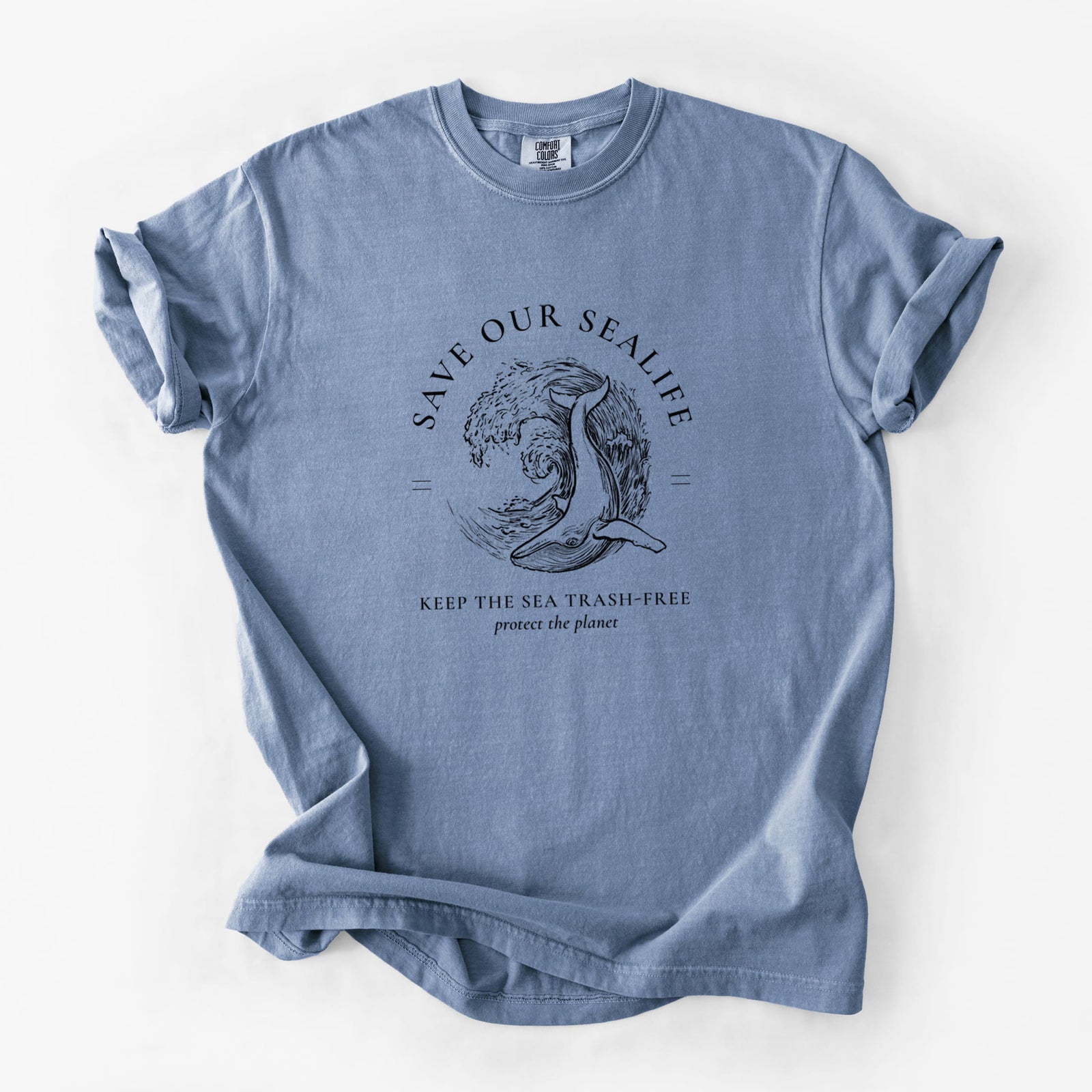 Chalky mint Comfort Colors t-shirt laid flat, printed with a black ink whale in an ocean wave framed by the words Save Our Sealife, Keep the Sea Trash-Free.