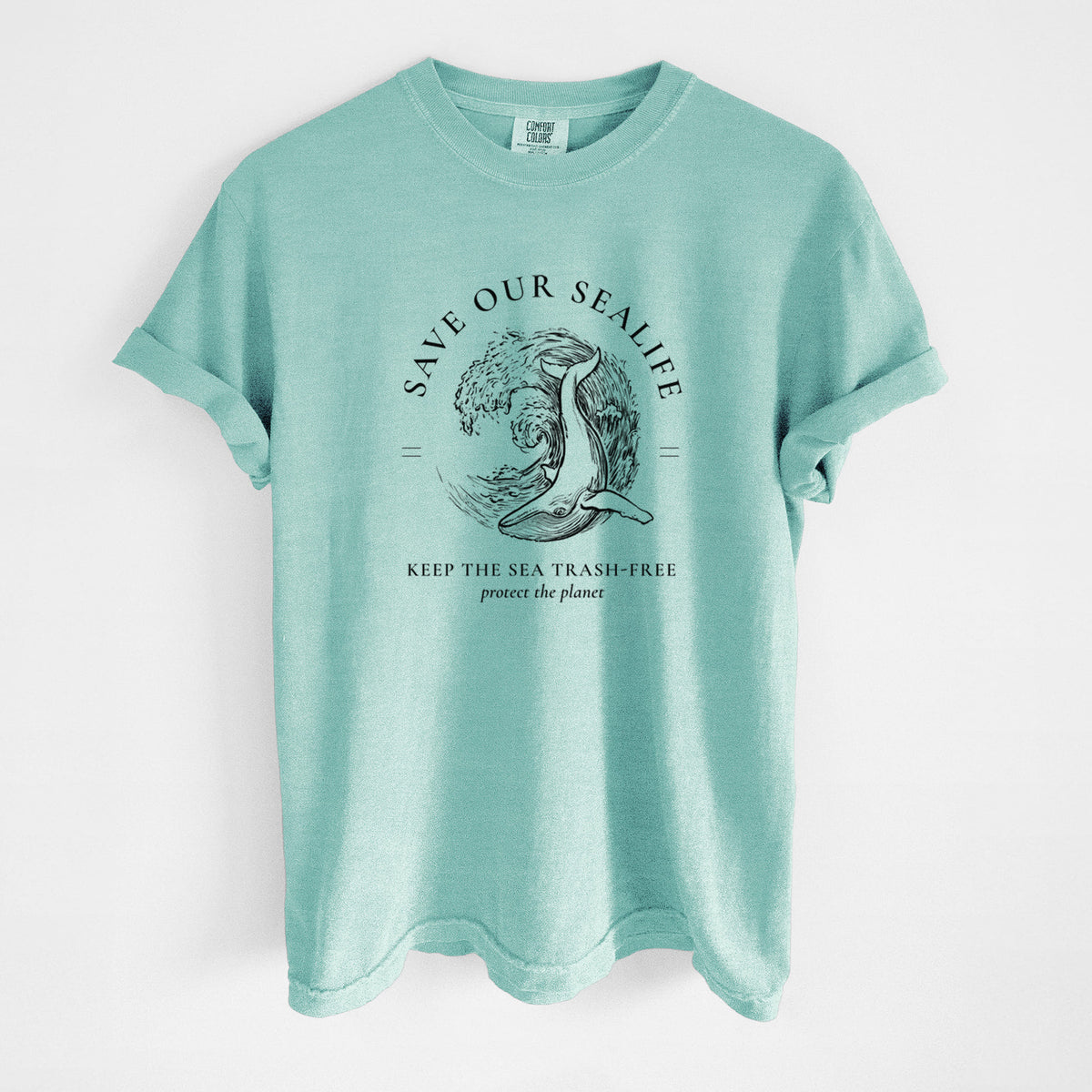 Chalky mint Comfort Colors t-shirt laid flat, printed with a black ink whale in an ocean wave framed by the words Save Our Sealife, Keep the Sea Trash-Free.