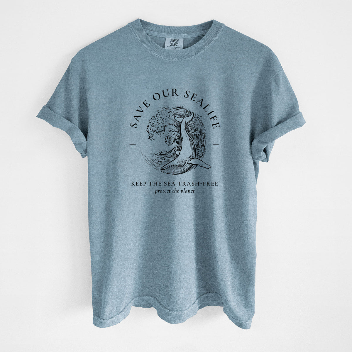Steel blue Comfort Colors t-shirt laid flat, printed with a black ink whale in an ocean wave framed by the words Save Our Sealife, Keep the Sea Trash-Free.