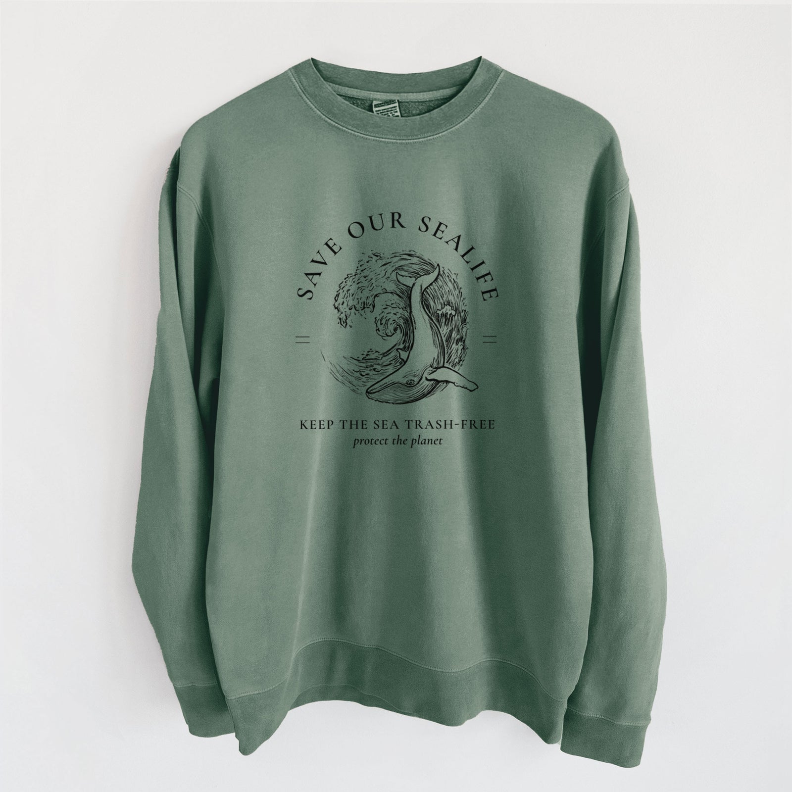 Alpine green pigment dyed crewneck sweatshirt laid flat, printed with a black ink whale in an ocean wave framed by the words Save Our Sealife, Keep the Sea Trash-Free.