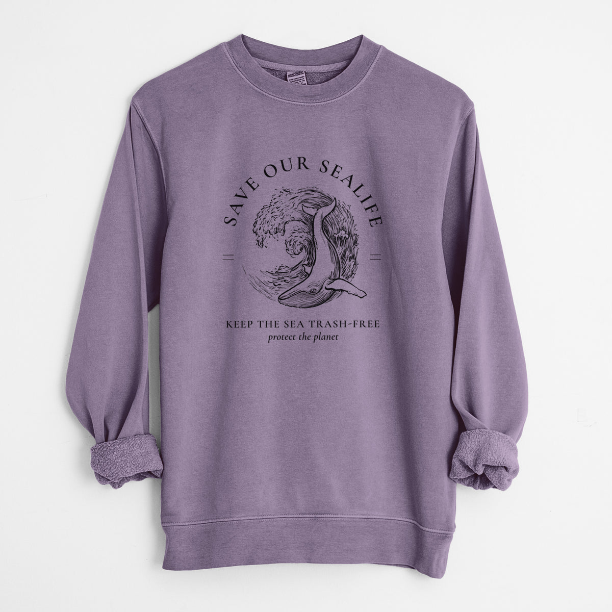 Plum purple pigment dyed crewneck sweatshirt laid flat with the sleeves rolled, printed with a black ink whale in an ocean wave framed by the words Save Our Sealife, Keep the Sea Trash-Free.
