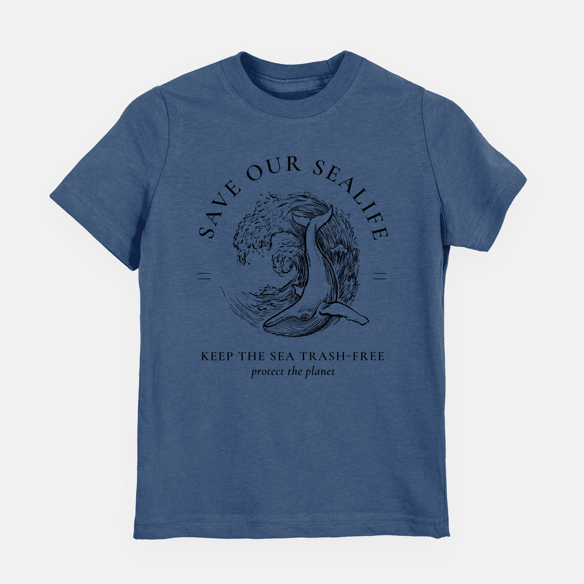 Indigo blue youth t-shirt laid flat, printed with a black ink whale in an ocean wave framed by the words Save Our Sealife, Keep the Sea Trash-Free.