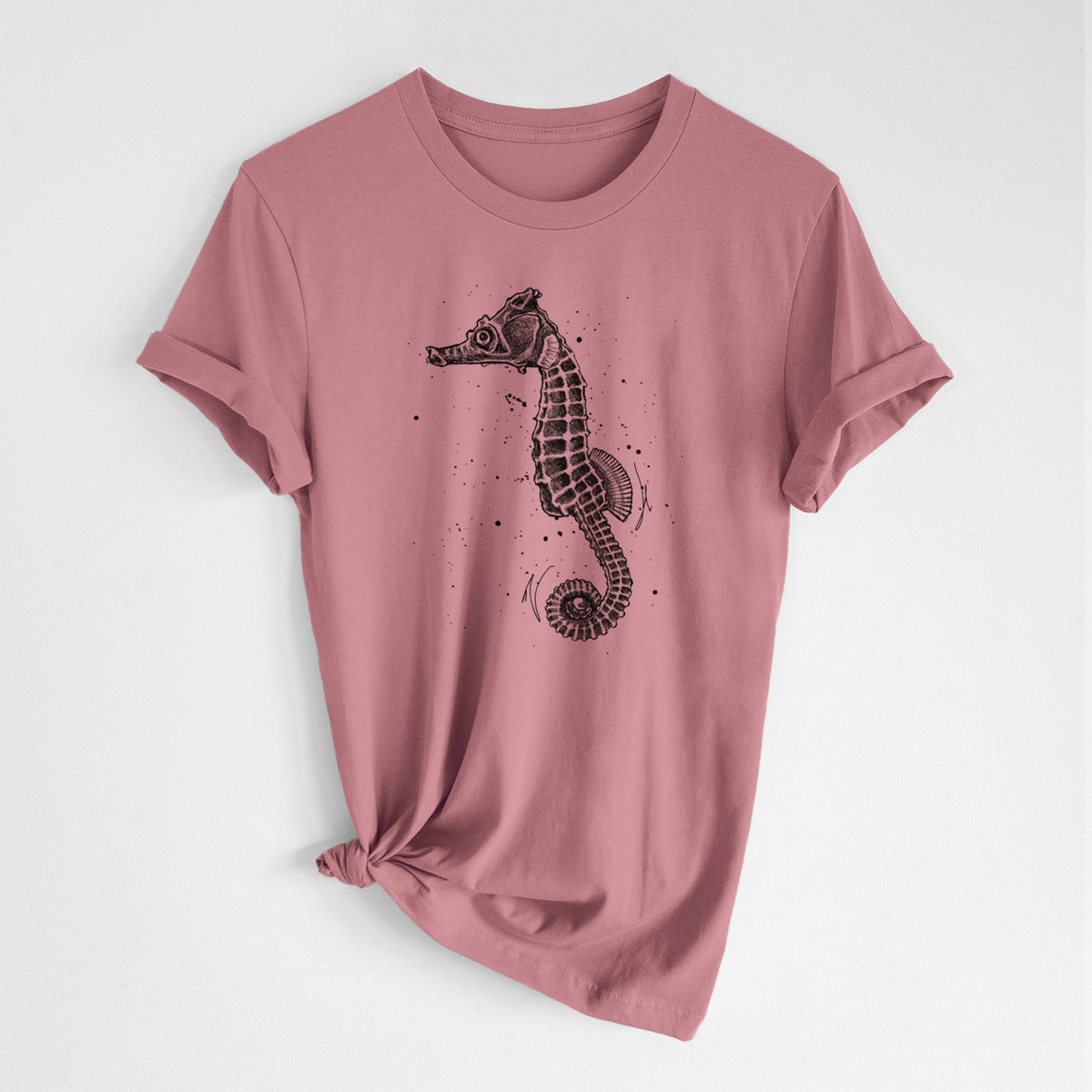 Mauve pink lightweight cotton t-shirt laid flat with the sleeves rolled, printed with a detailed black ink illustration of a Pacific seahorse with its tail curled.