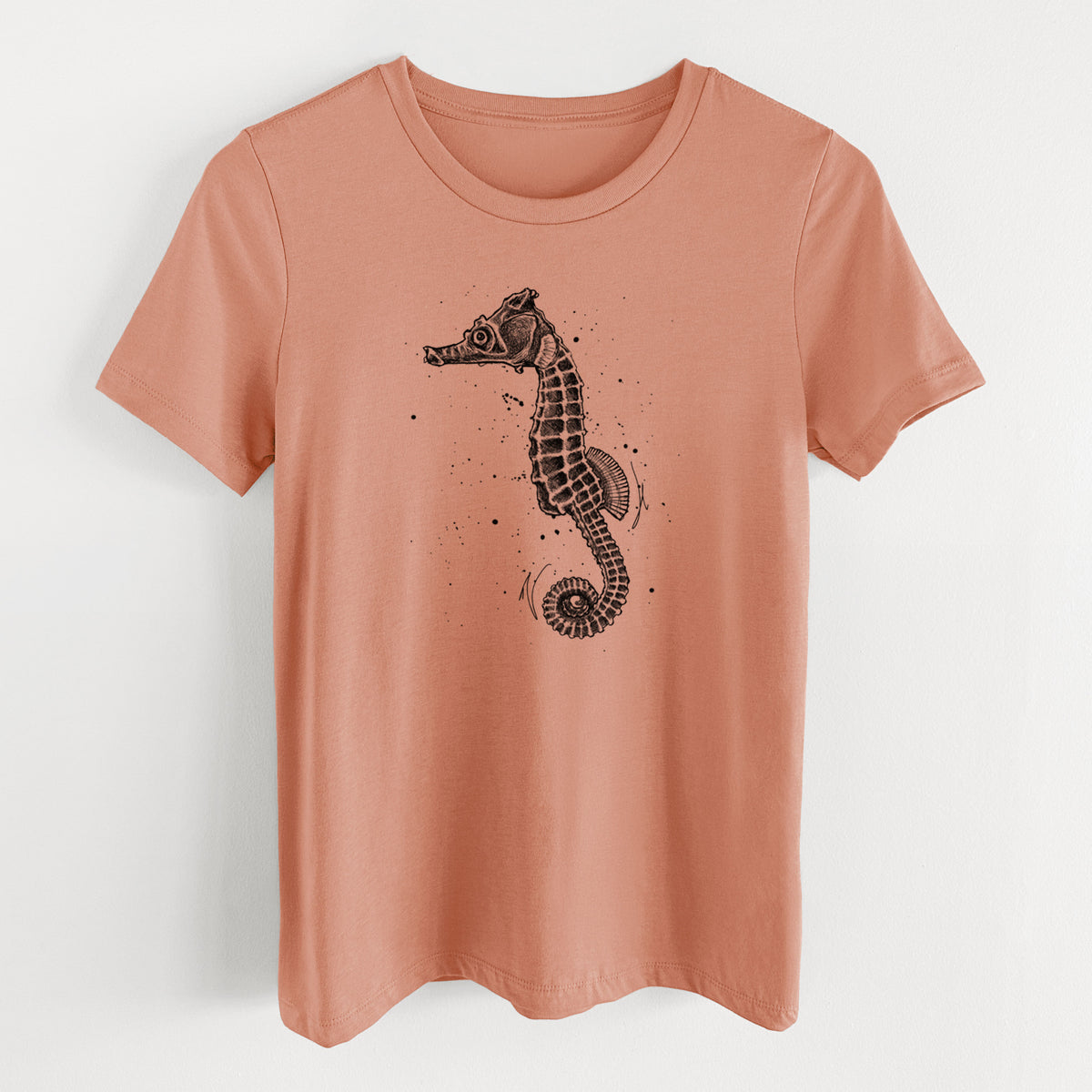 Terracotta orange women's relaxed fit cotton t-shirt laid flat, printed with a detailed black ink illustration of a Pacific seahorse with its tail curled.