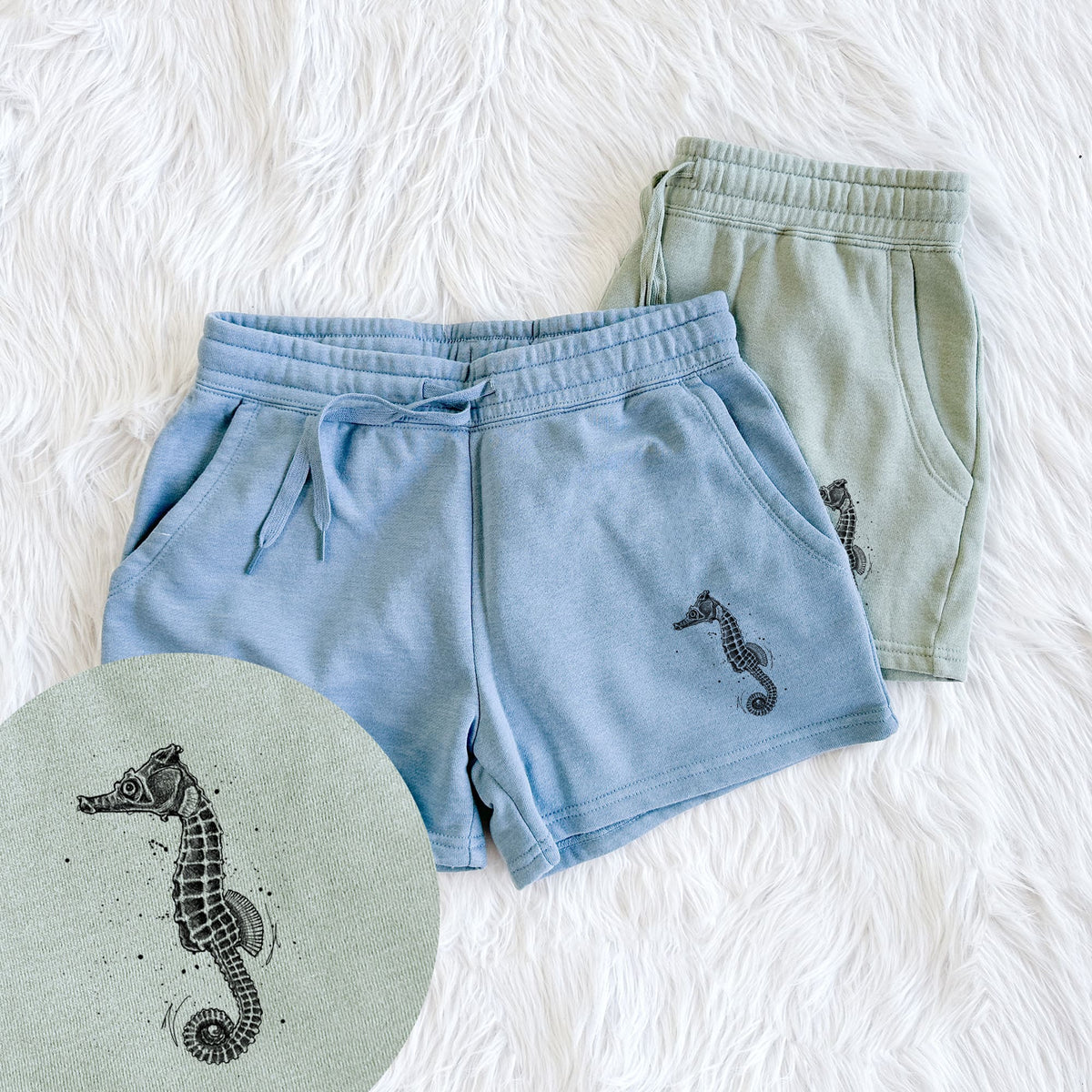Two pairs of Cali Wave shorts in different colors printed with a detailed black ink illustration of a Pacific seahorse with its tail curled, with a close-up of the print.