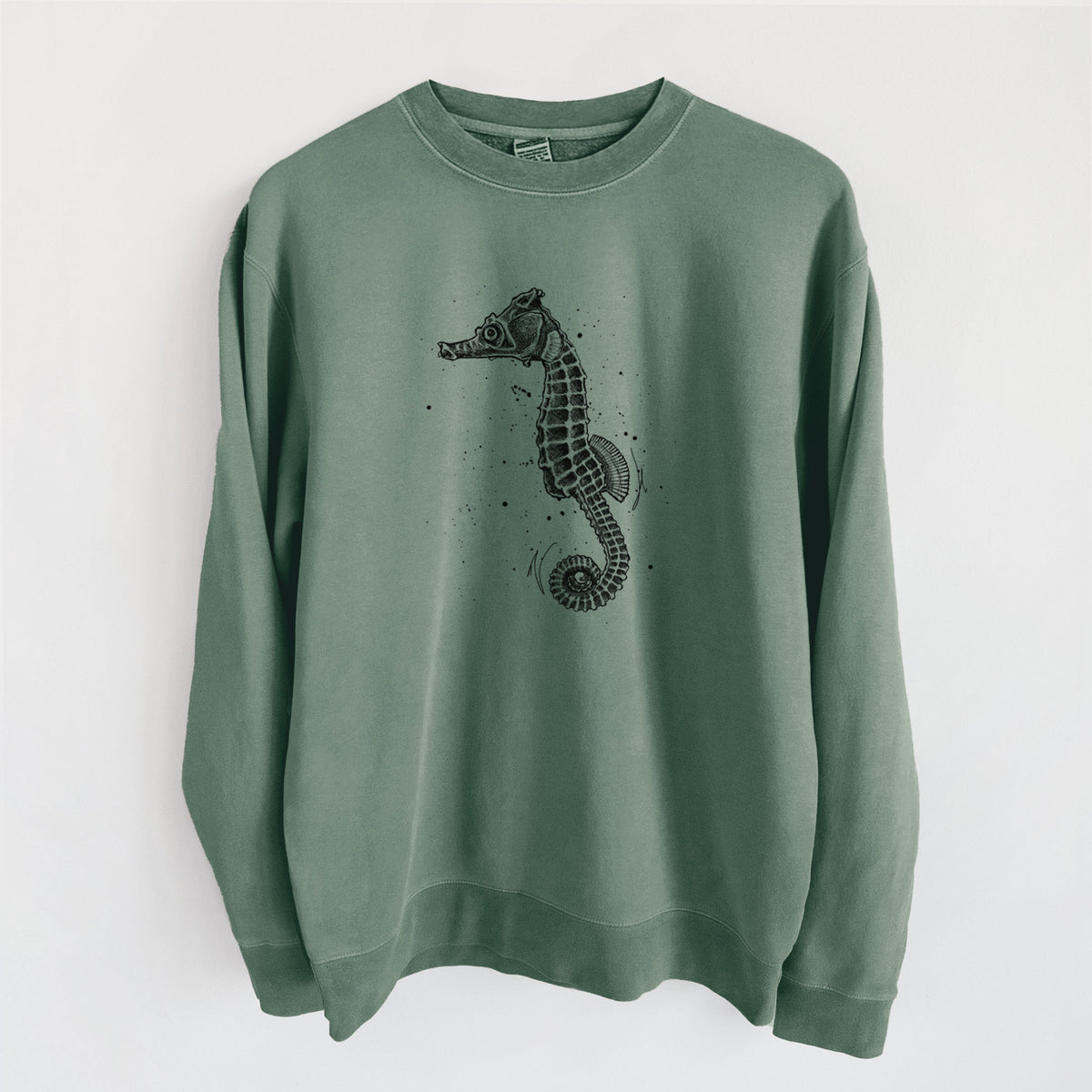 Alpine green pigment dyed crewneck sweatshirt laid flat, printed with a detailed black ink illustration of a Pacific seahorse with its tail curled.