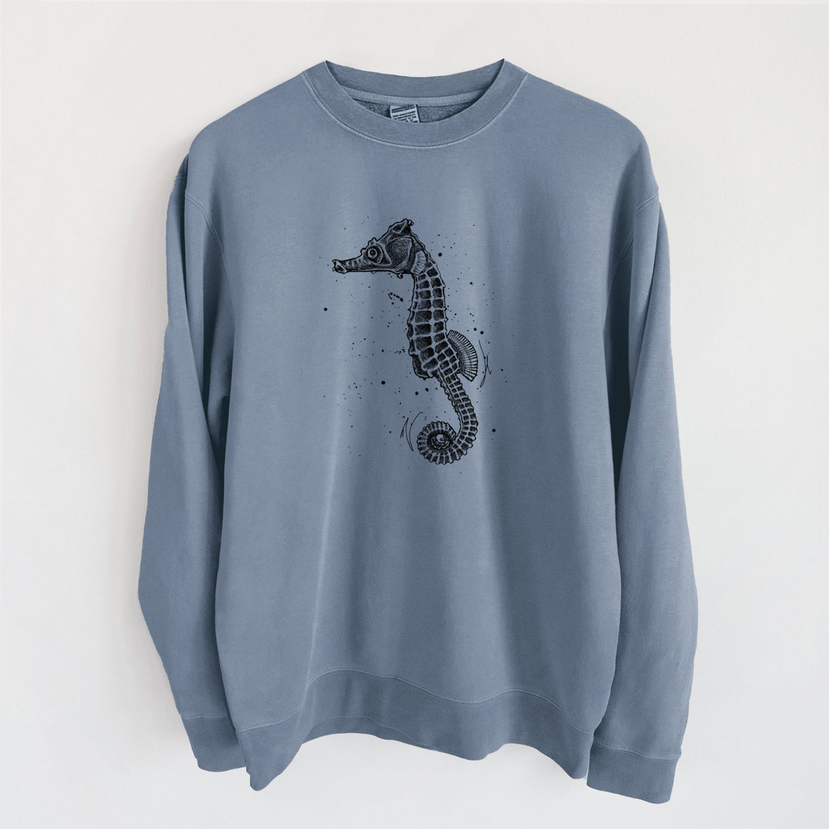 Slate blue pigment dyed crewneck sweatshirt laid flat, printed with a detailed black ink illustration of a Pacific seahorse with its tail curled.