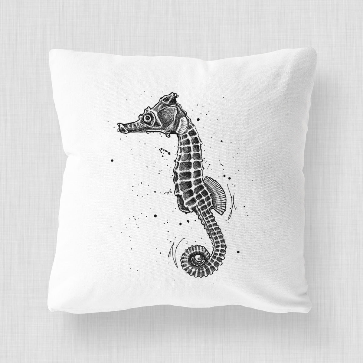 White pillow cover printed with a detailed black ink illustration of a Pacific seahorse with its tail curled.