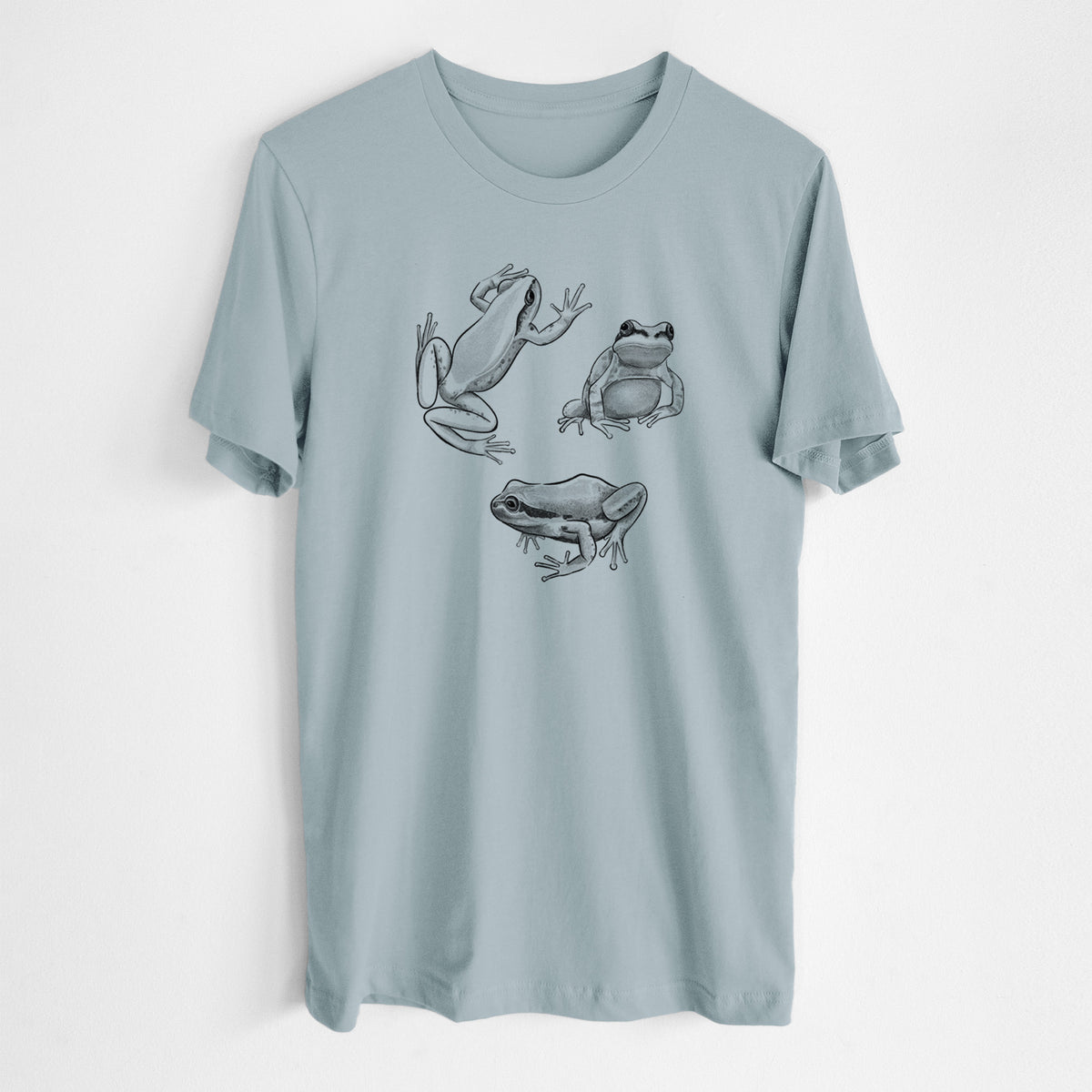 Vintage denim lightweight cotton t-shirt laid flat, printed with a black ink illustration of three Pacific tree frogs in different poses.