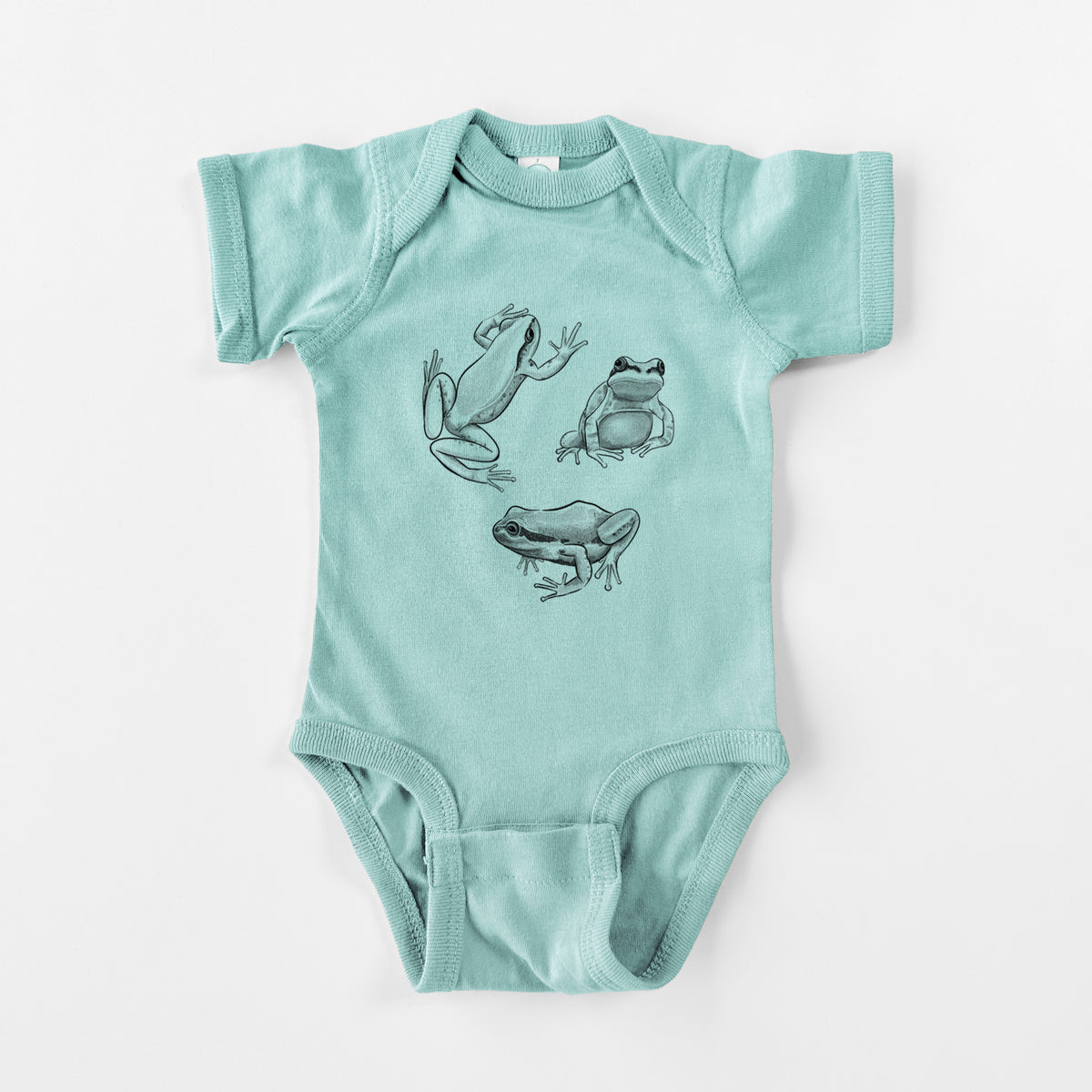 Saltwater baby bodysuit laid flat, printed with a black ink illustration of three Pacific tree frogs in different poses.