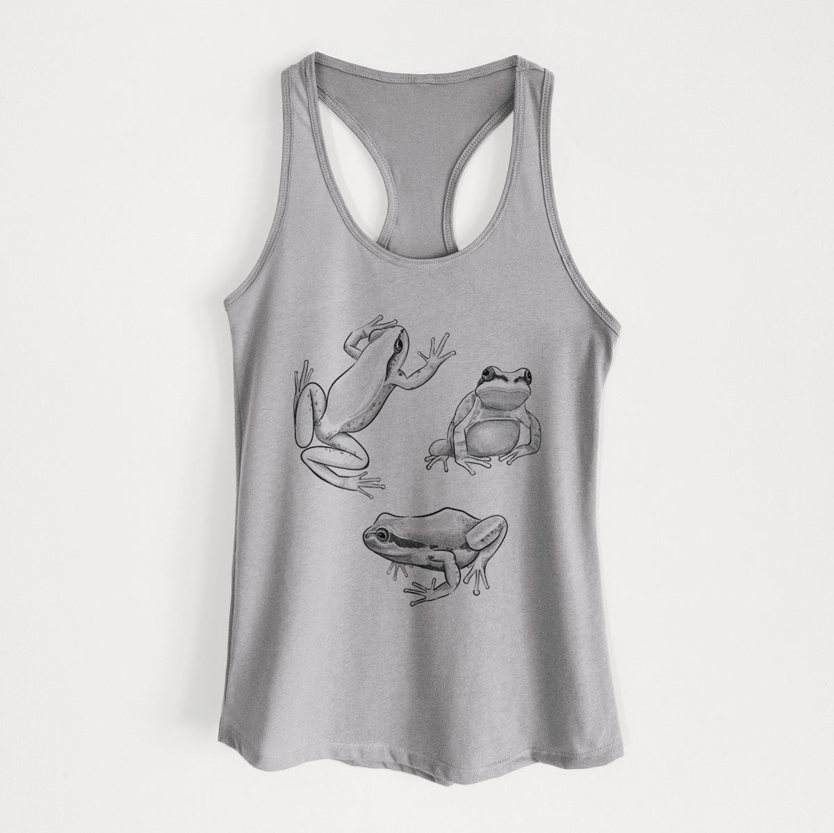 Heather grey women's racerback tank top laid flat, printed with a black ink illustration of three Pacific tree frogs in different poses.