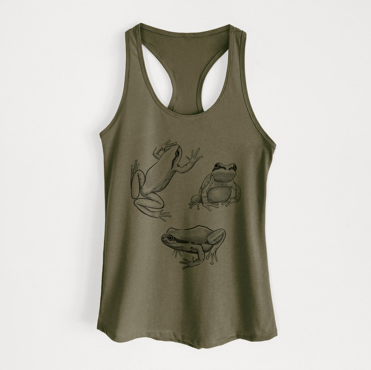 Military green women's racerback tank top laid flat, printed with a black ink illustration of three Pacific tree frogs in different poses.