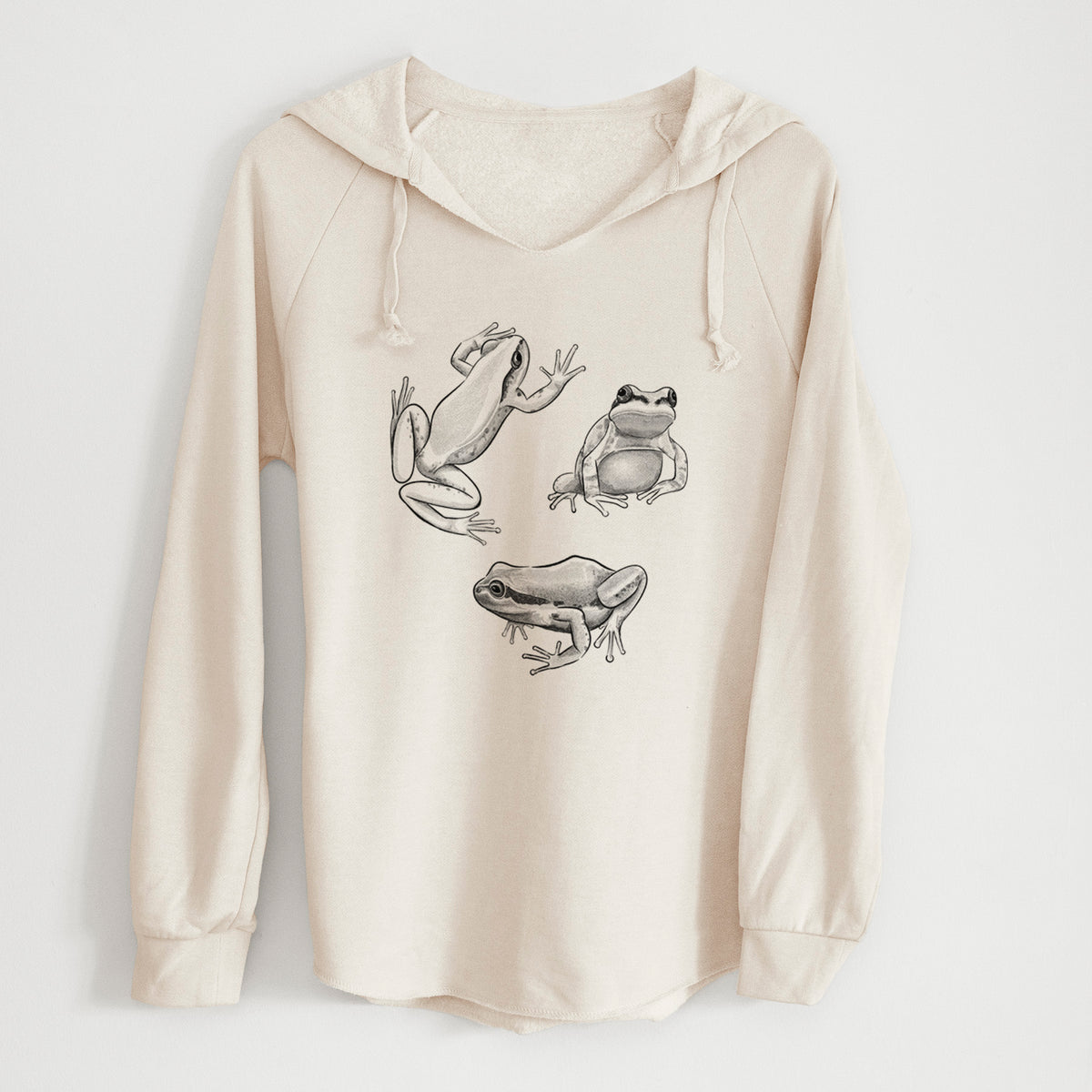 Bone cream women's Cali Wave hooded sweatshirt laid flat, printed with a black ink illustration of three Pacific tree frogs in different poses.